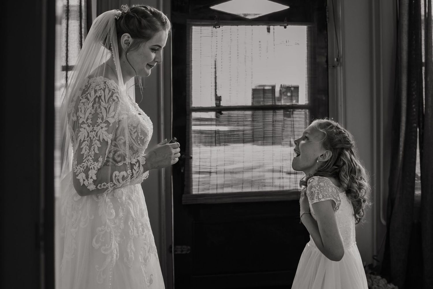 Bride and groom share an intimate moment during their first dance at an elegant indoor wedding reception.