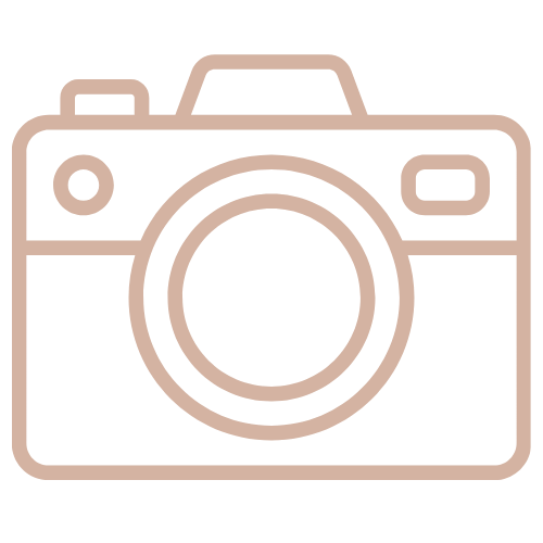 Minimalist camera icon outline in soft rose gold color on white background.