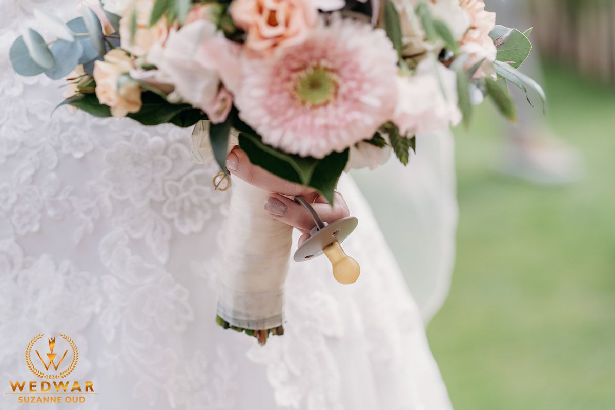 Close-up of delicate pink wedding bouquet with lace detail.