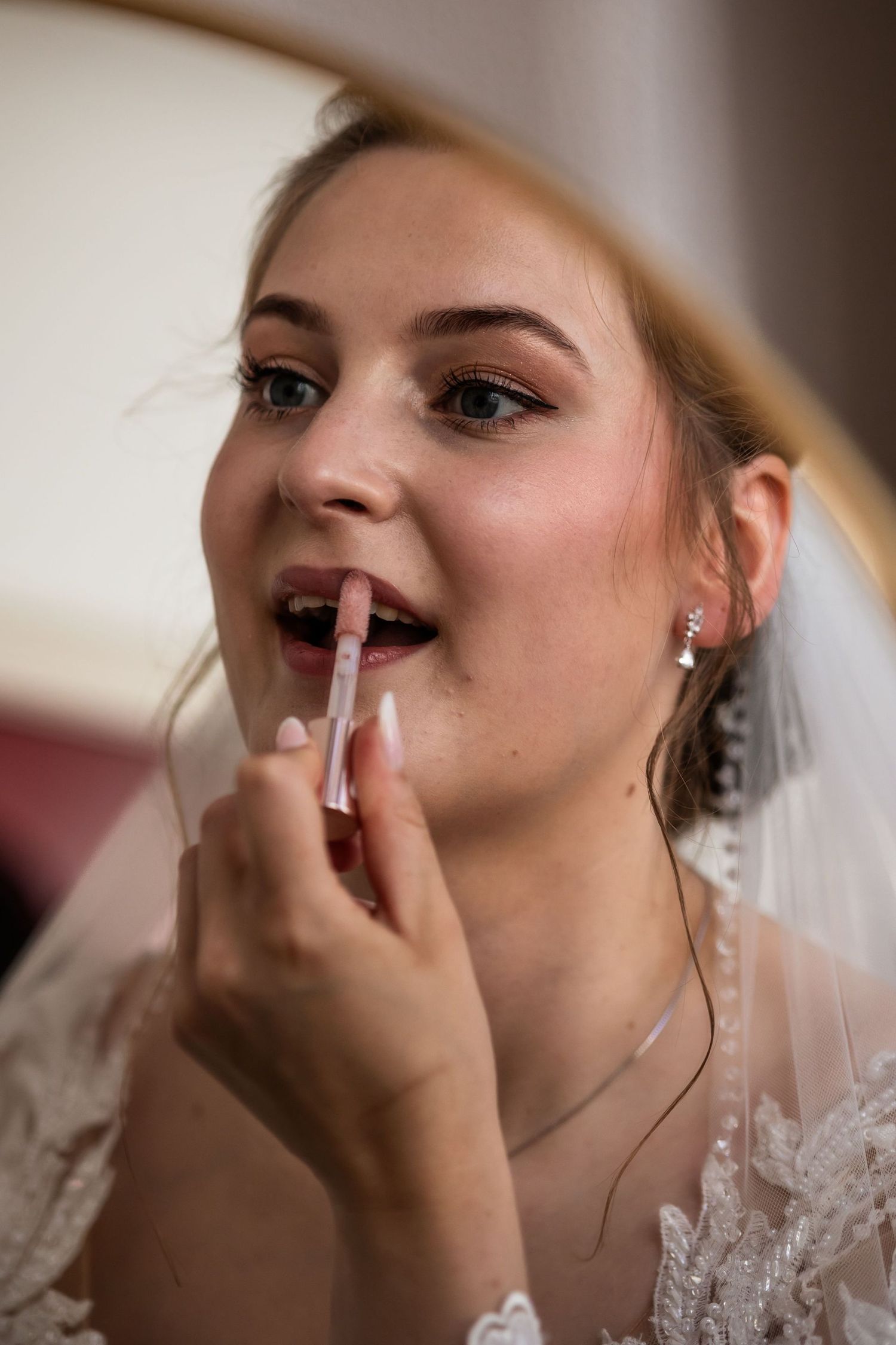Close-up sequence of bride getting makeup applied during wedding preparations.