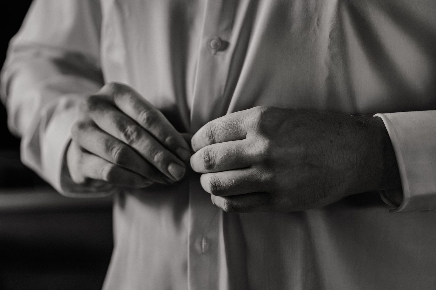 Close-up of hands exchanging wedding rings during an intimate ceremony.