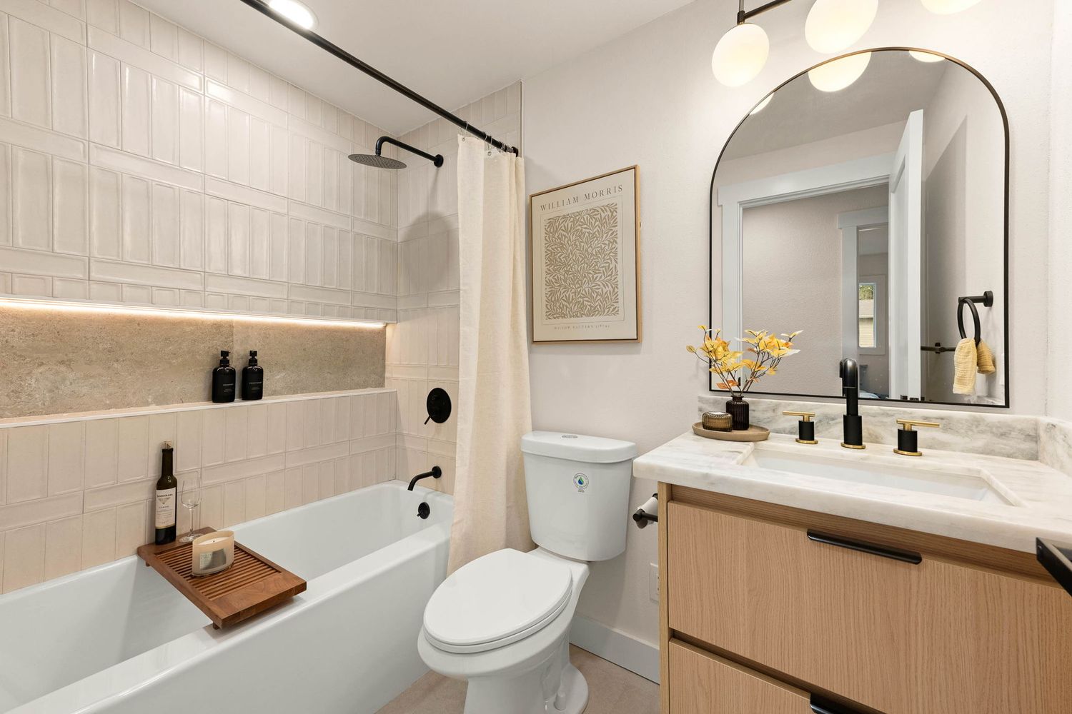 A modern minimalist bathroom interior with white walls, wood accents, and sleek fixtures shown from multiple angles.