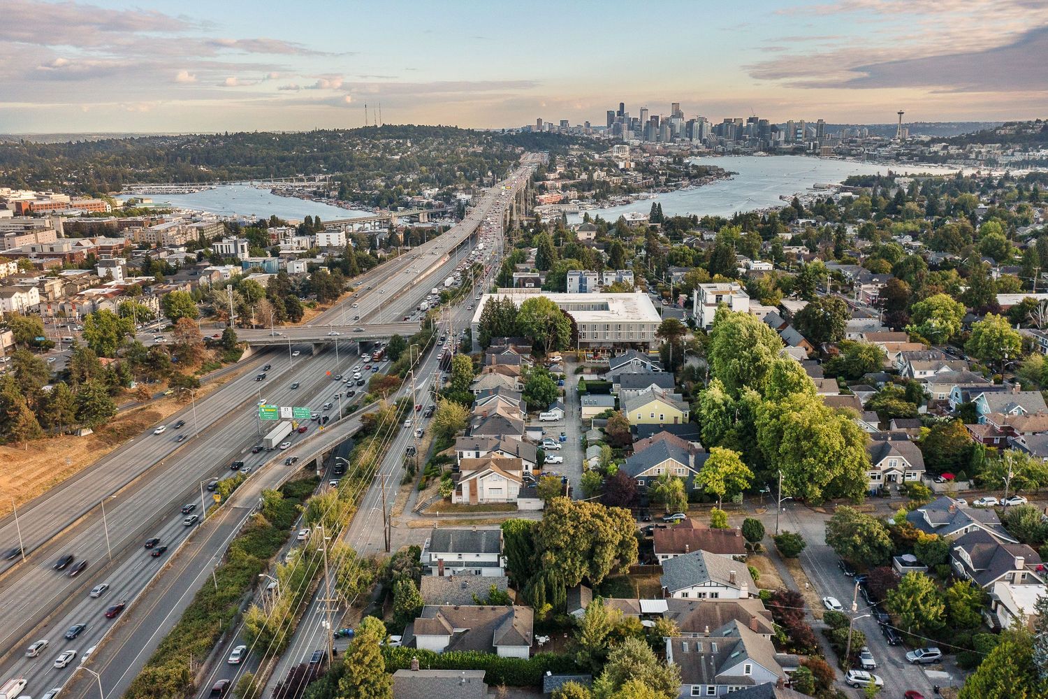 Aerial view of Seattle showing Interstate 5 leading to downtown with Lake Union and residential neighborhoods visible.