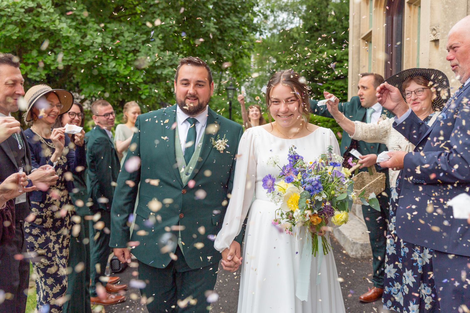 A bride and groom being showered in confetti at Malvern register office.