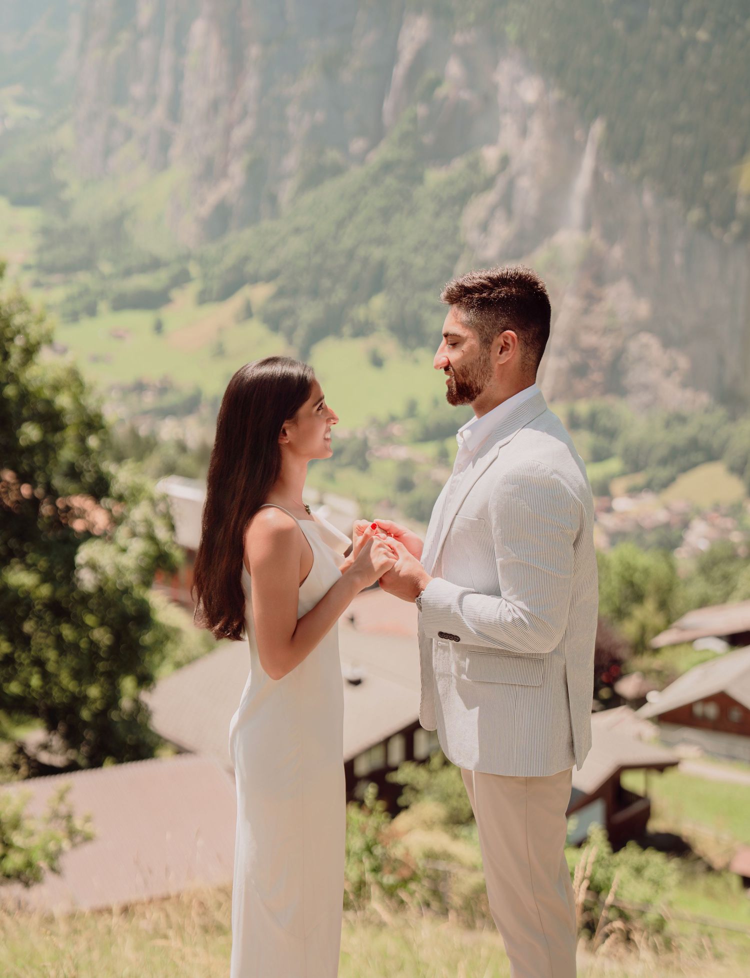 Couple exchanging rings during intimate outdoor elopement ceremony in Swiss Alpine village.