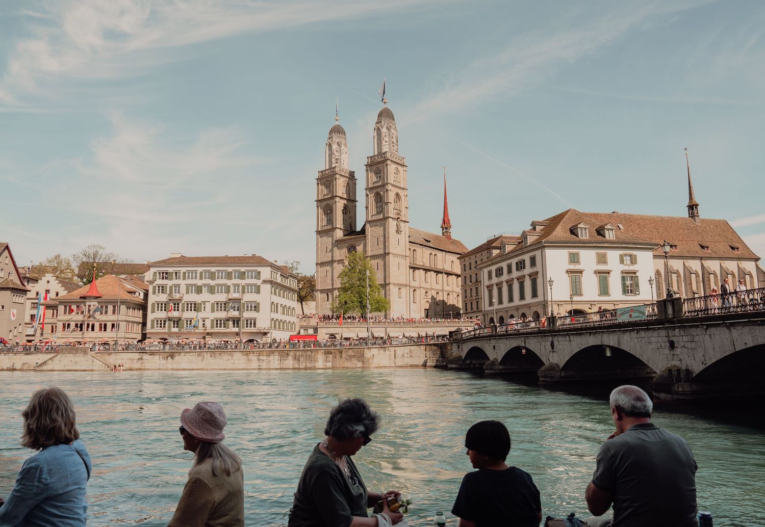 Scenic view of Grossmunster cathedral and bridge over Limmat River in Zurich Switzerland.