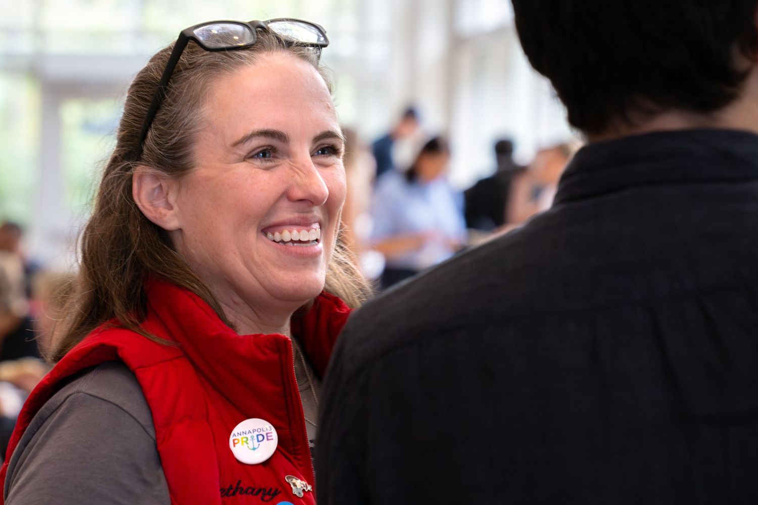 Bethany Swain in a red vest smiles during a Video Consortium event.