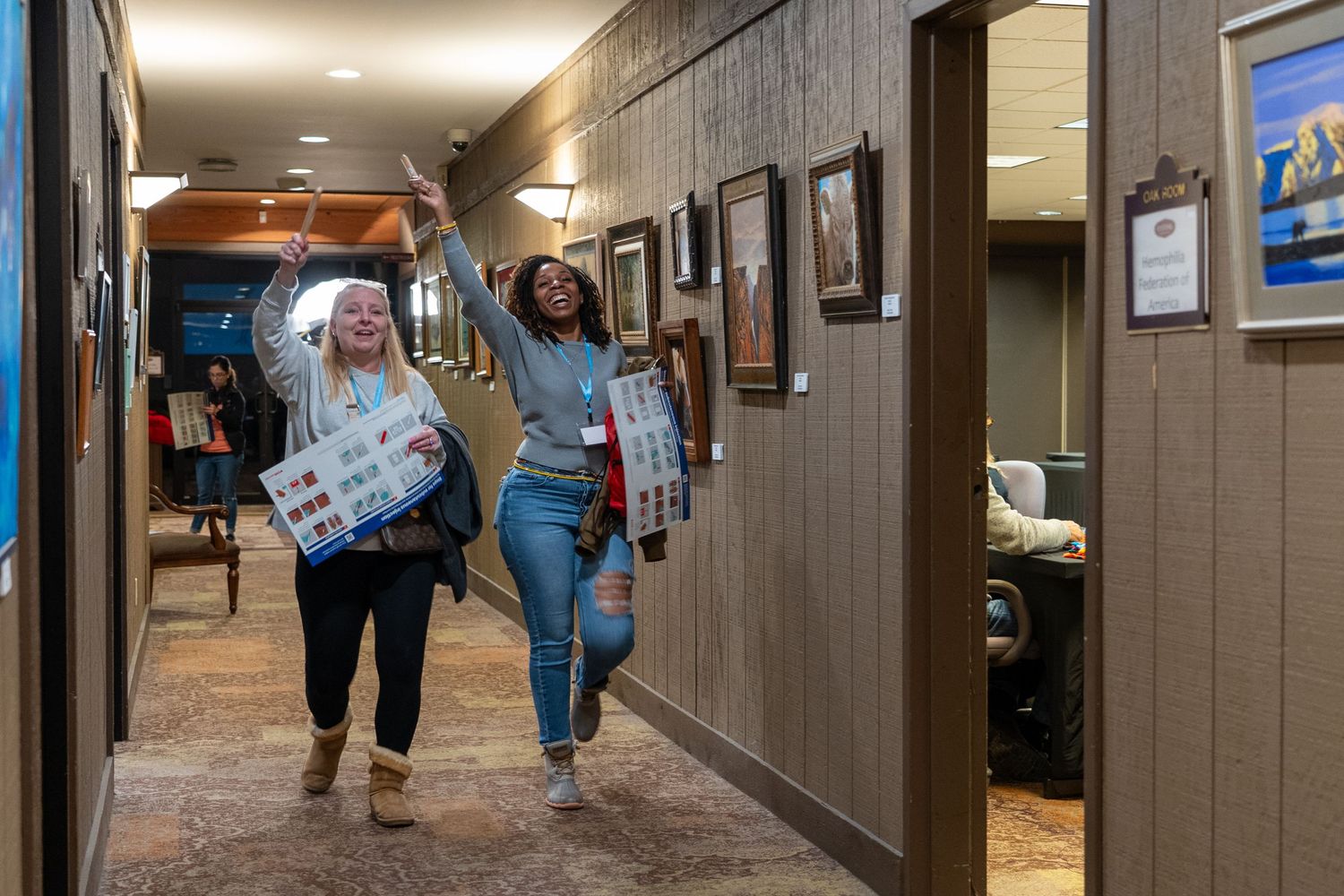 Students walk through a school hallway decorated with colorful posters and artwork.