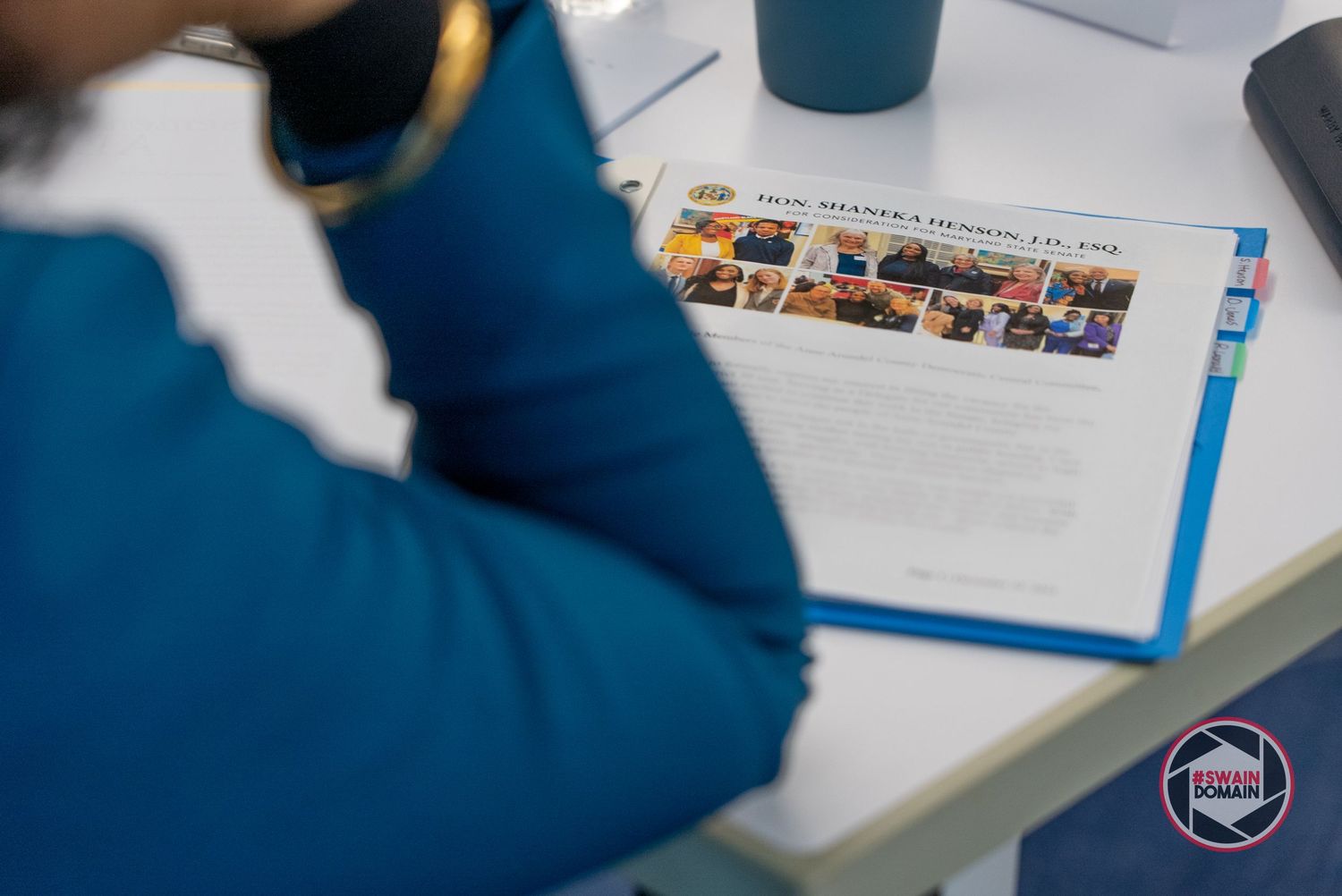 Close-up of paperwork and documents on a desk during a meeting.