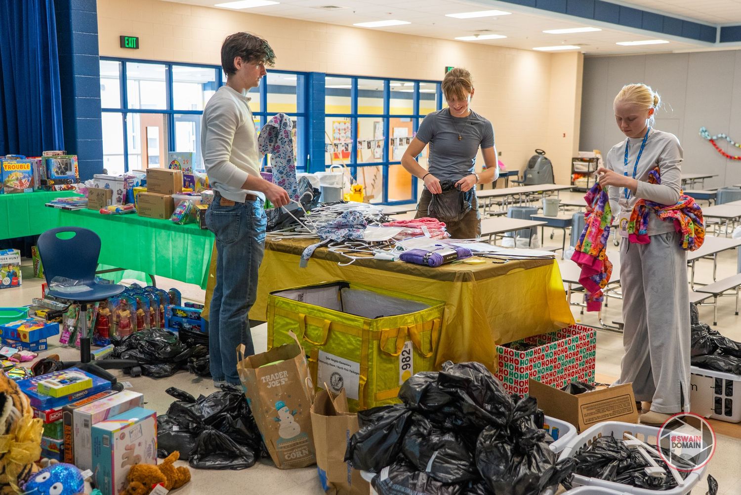 Classroom filled with tables, chairs and supplies during a school donation drive.