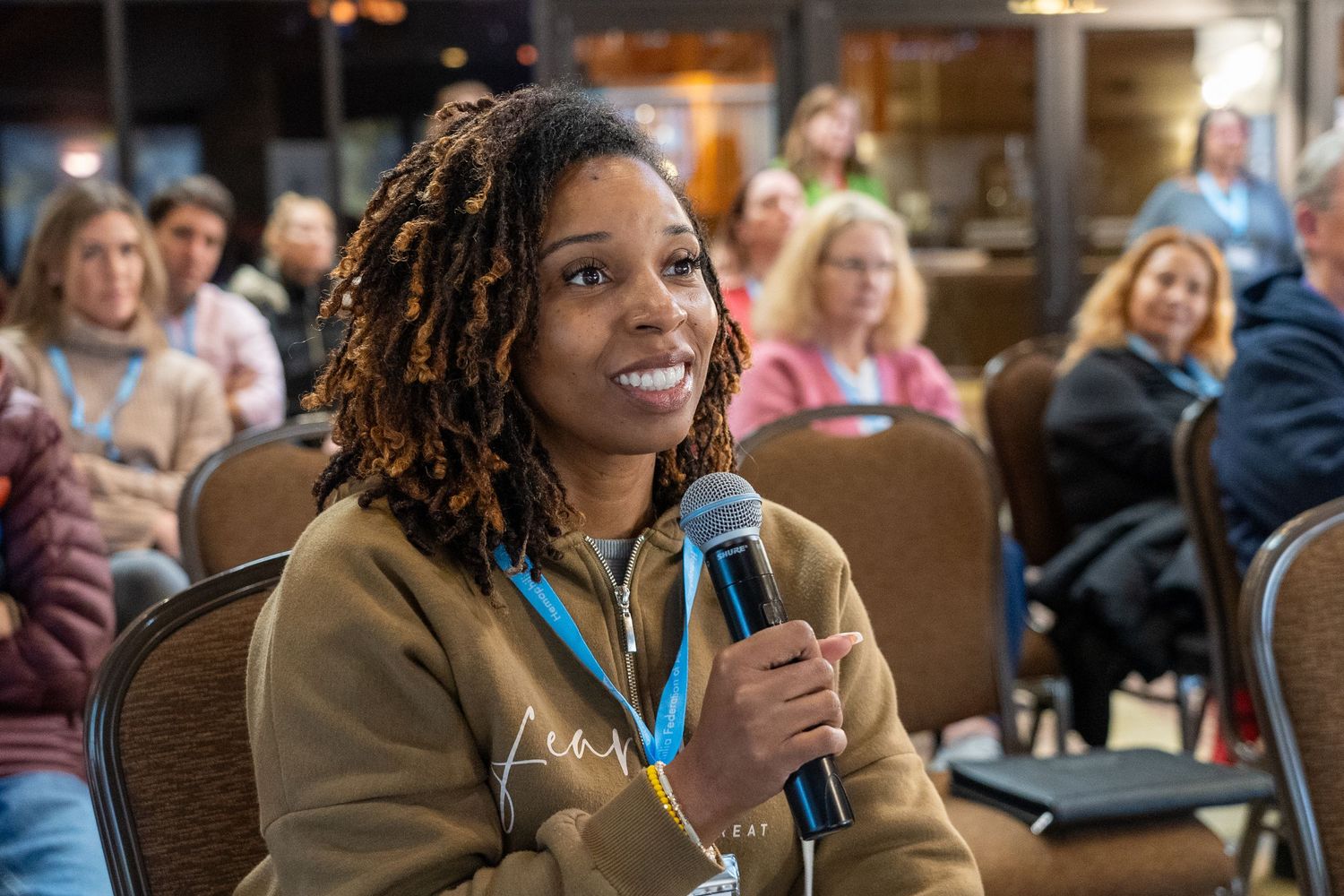 Attendees participating in an animated discussion during a conference session.