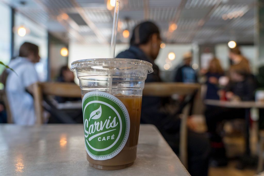 Coffee shop interior with Sonic branded cups and cafe ambiance.