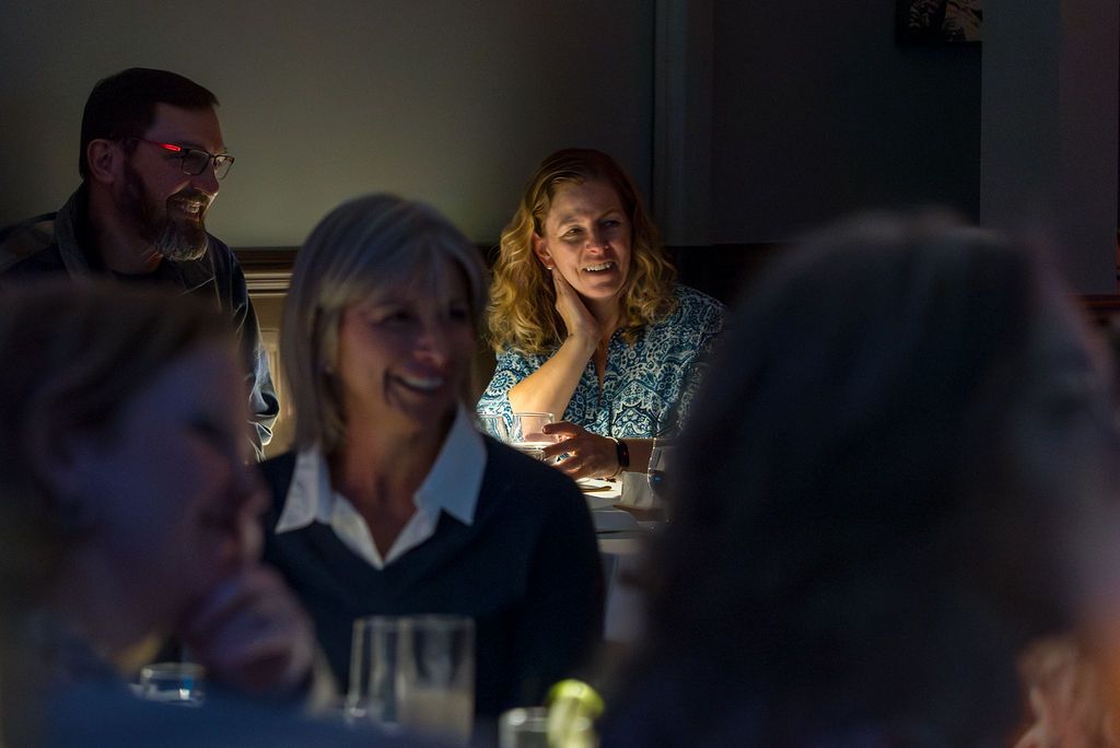 Dark restaurant interior with diners enjoying their meals at tables.