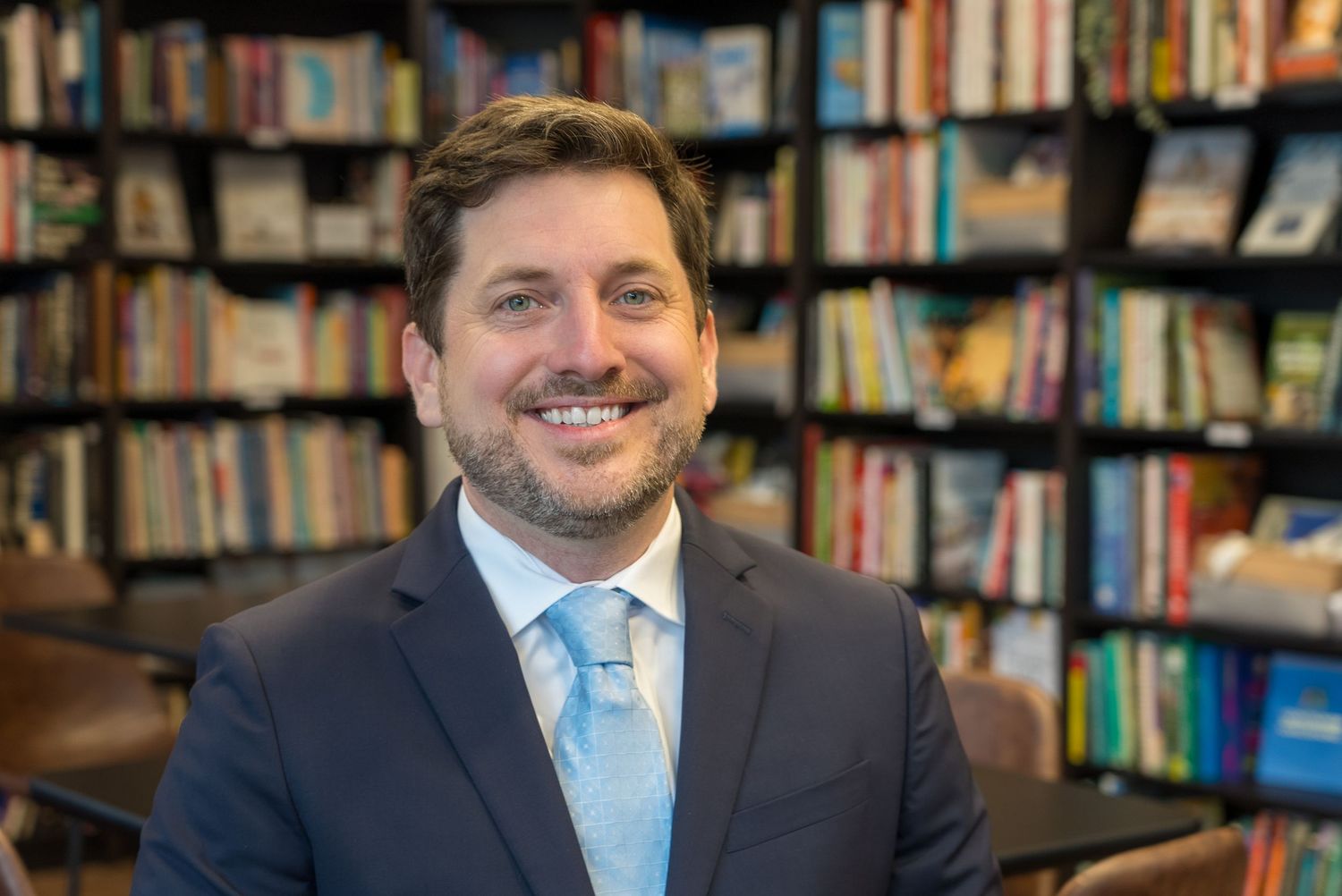 Swain Domain's professional interview setup of Jeremy York in library setting with bookshelves in background.