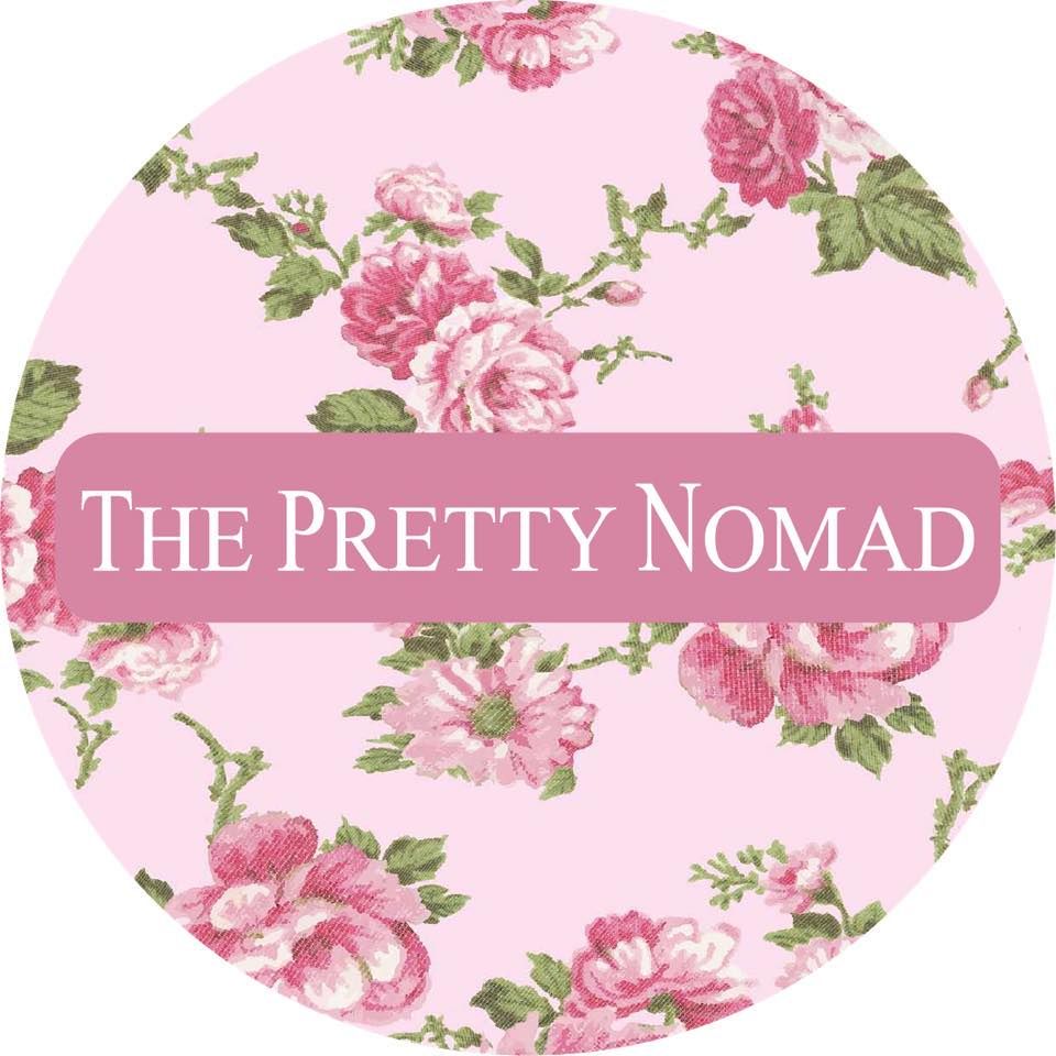 Pink and floral logo design for The Pretty Nomad with vintage rose pattern background.