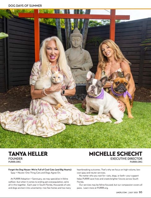 Two women in floral dresses sit on grass with pets beside a Buddha statue in an outdoor garden setting.