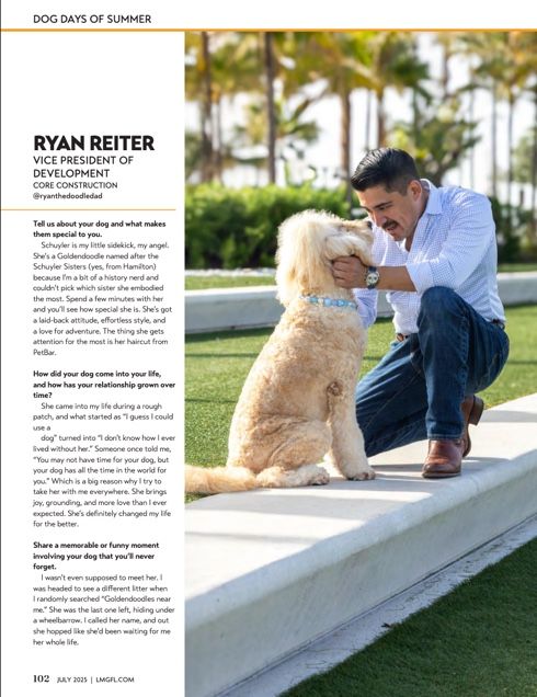 A person and a golden doodle dog sit together on white steps outdoors on a sunny day with palm trees in background.