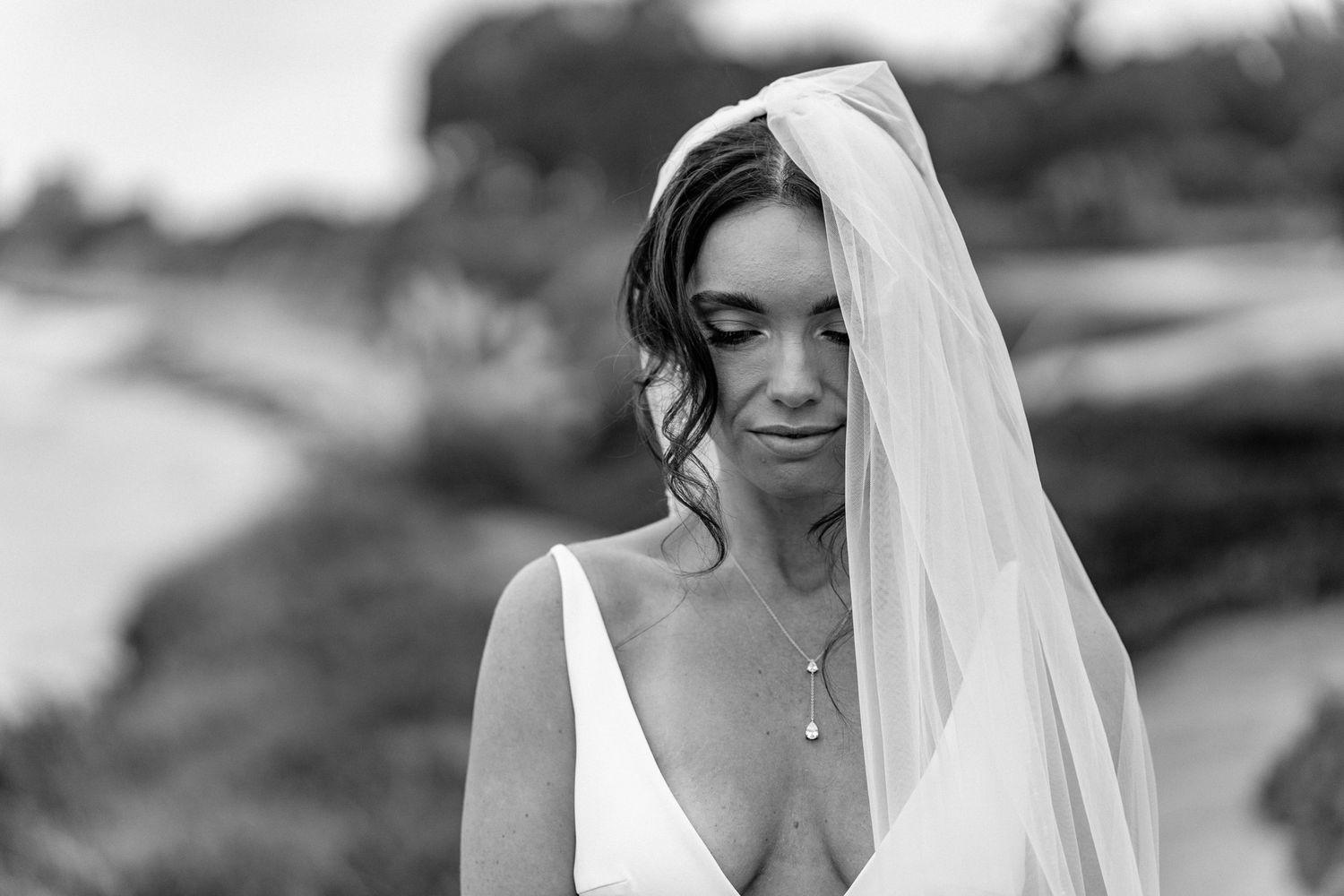 Intimate black and white bridal portrait with delicate veil.