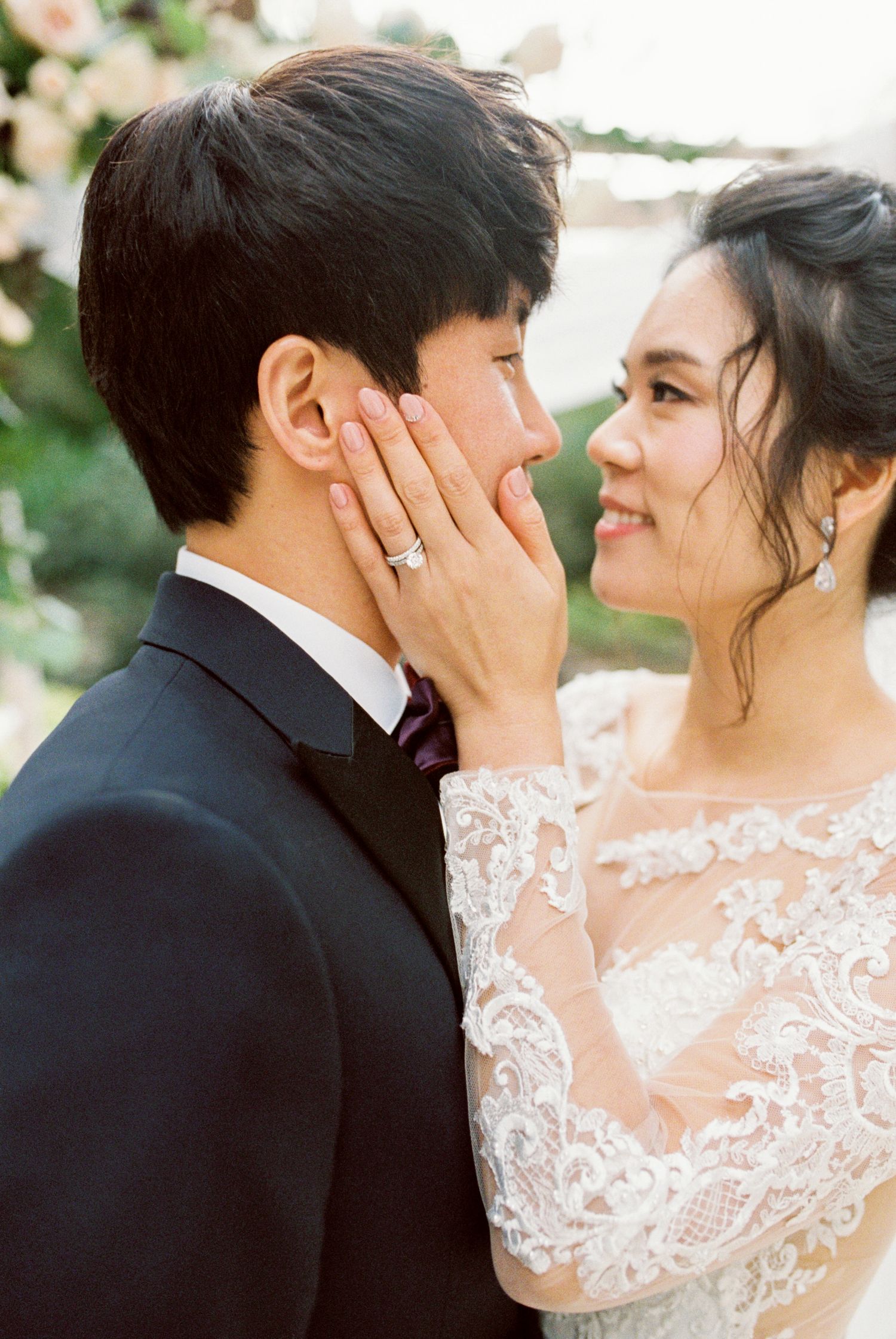Intimate wedding portraits showing tender moments between newlyweds with bride in lace gown.