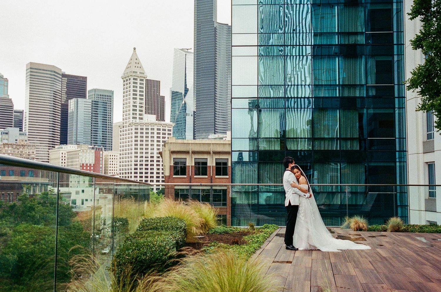 A cityscape wedding photo featuring modern architecture and urban skyline views.
