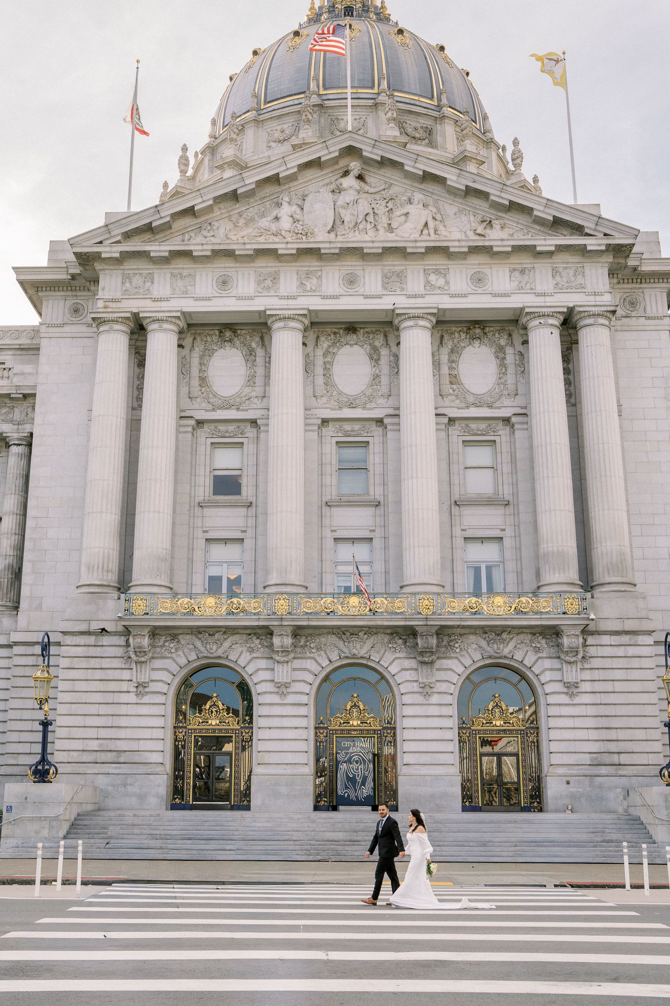 San Francisco City Hall's grand Beaux-Arts architecture serves as backdrop for wedding photos.