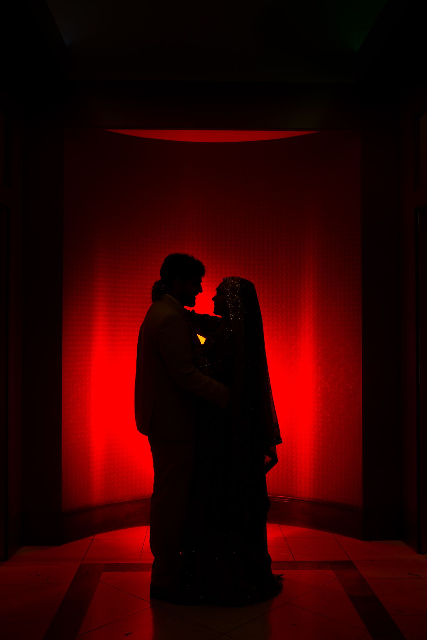 Artistic silhouette photos with red lighting showing romantic couple poses.
