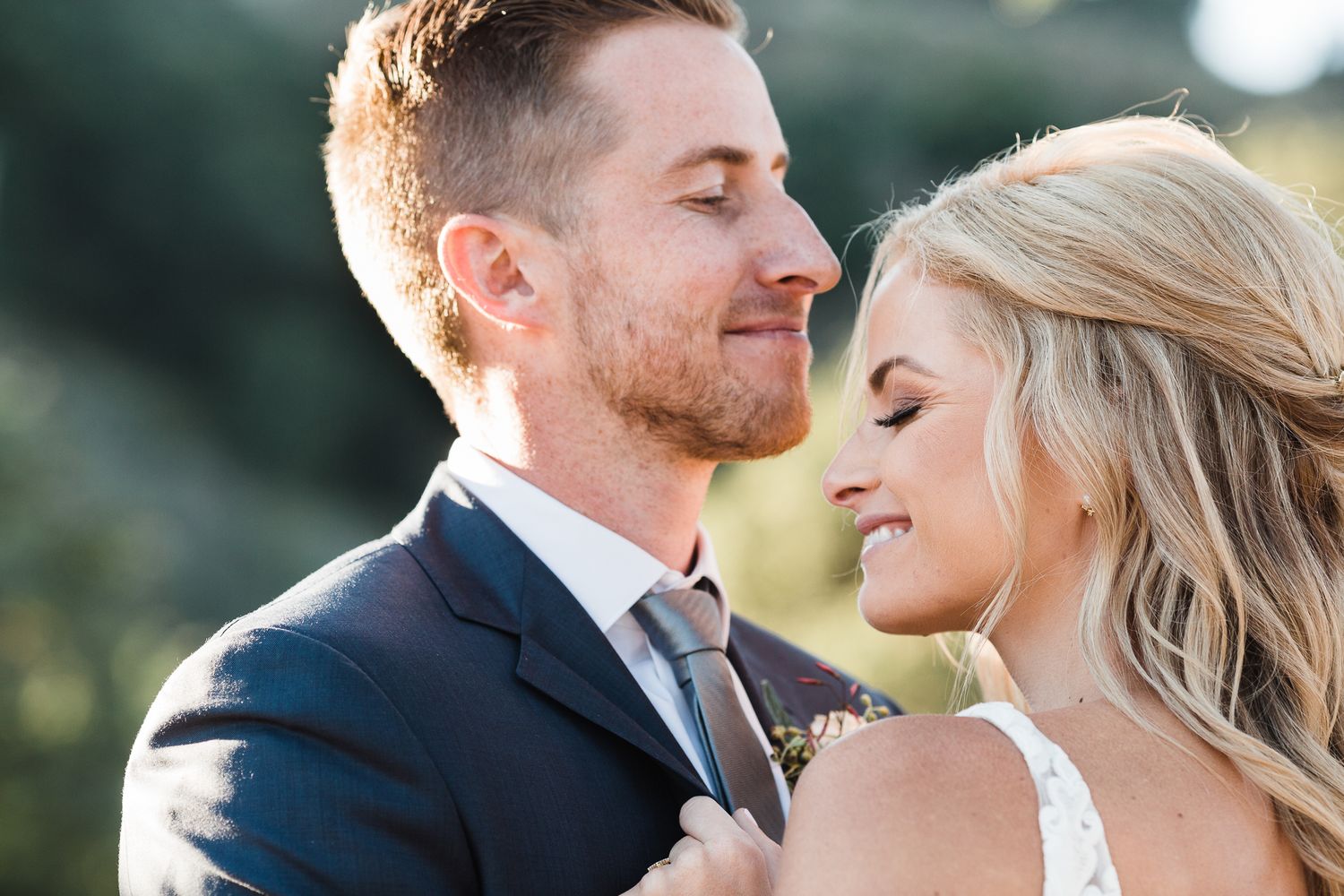 Romantic wedding portraits captured in soft natural lighting during golden hour.