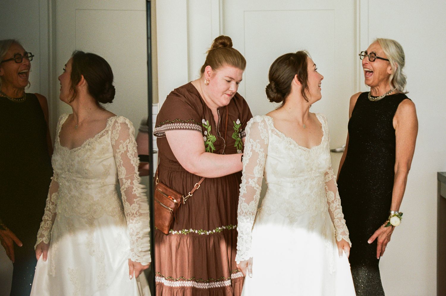 Wedding party gathers for candid getting ready moments in light-filled room.
