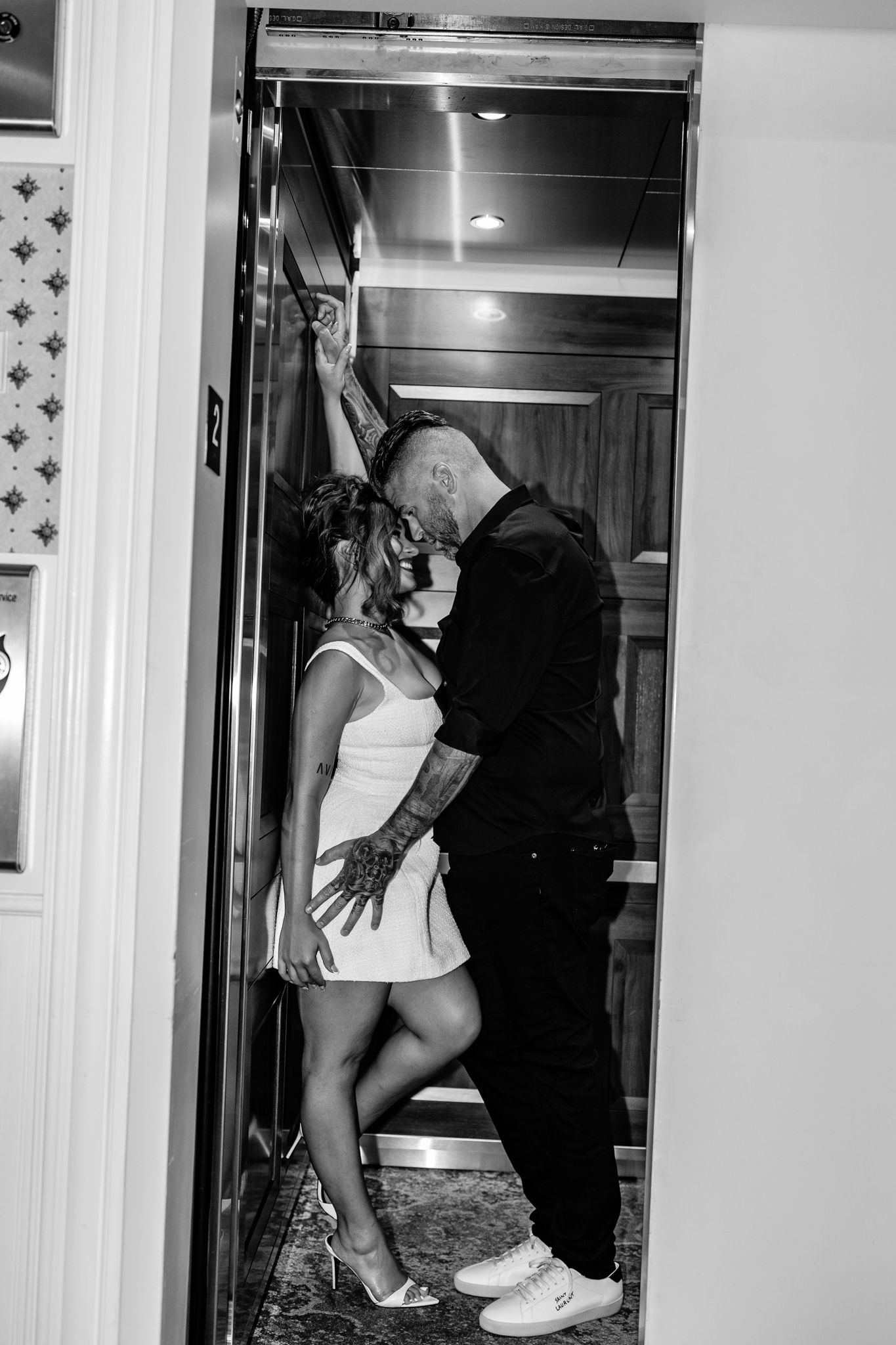 Black and white photo series showing someone in white sneakers and athletic wear posing in a mirrored doorway.