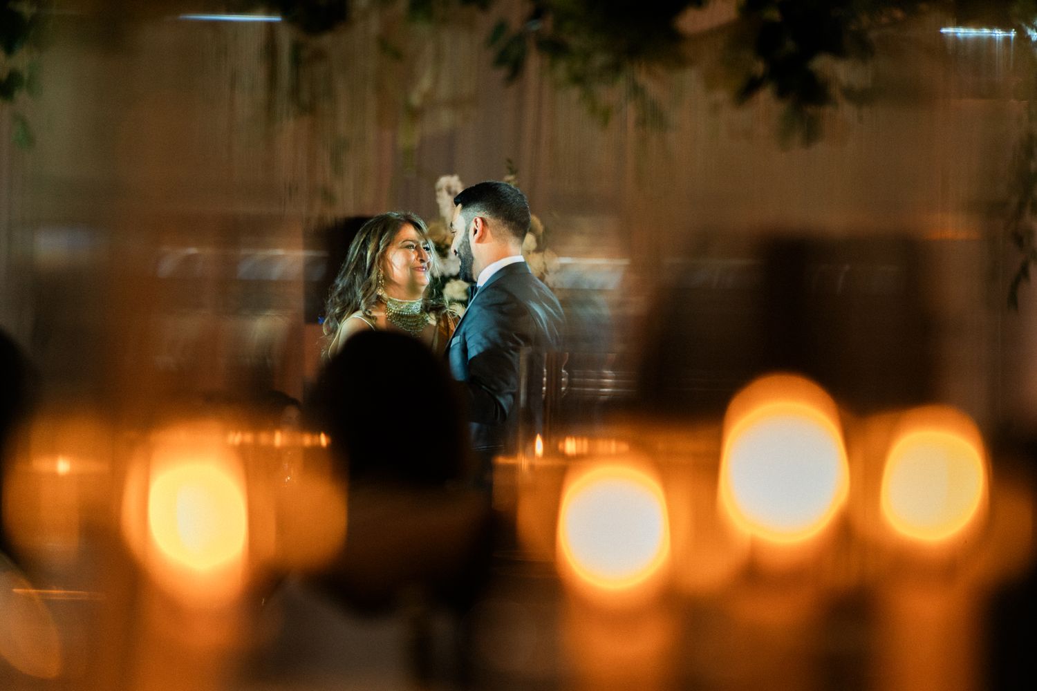 Atmospheric wedding scene with glowing bokeh lights creating a dreamy ambiance.