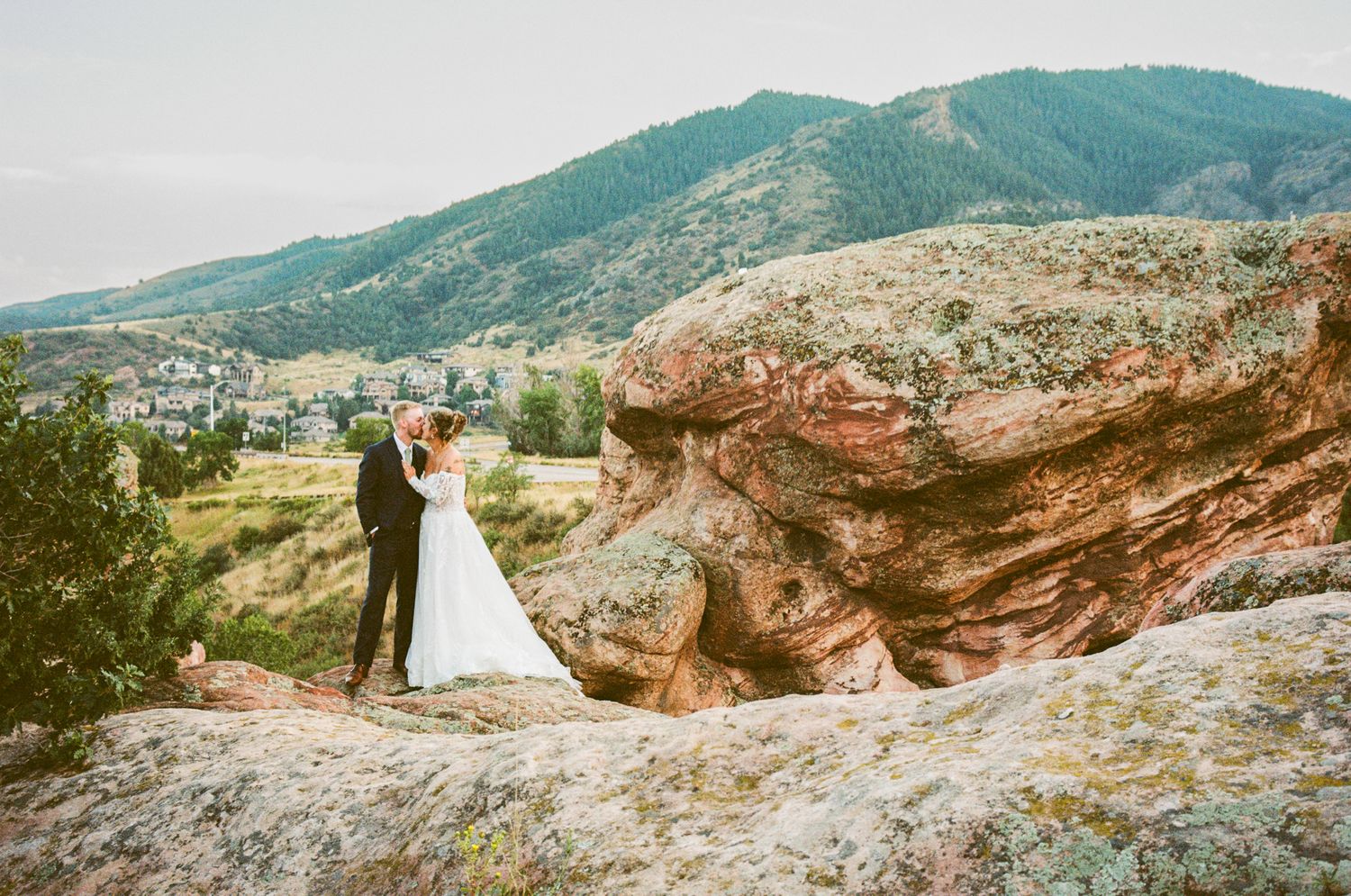 Dramatic mountain landscape wedding photos with rocky cliffs and panoramic valley views.