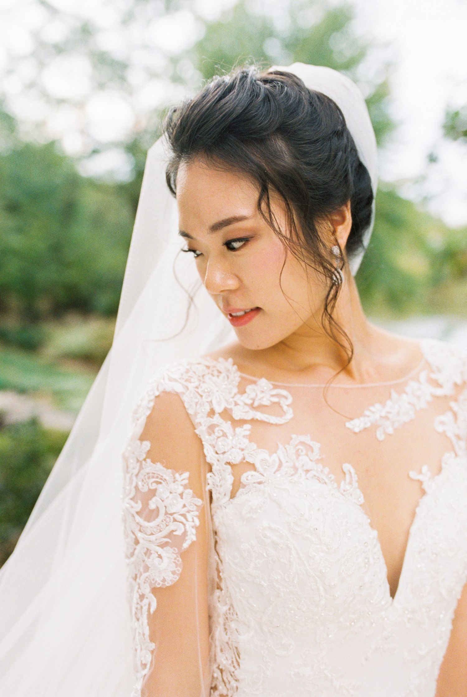 Elegant bridal portraits showcasing intricate lace details of wedding dress against natural backdrop.
