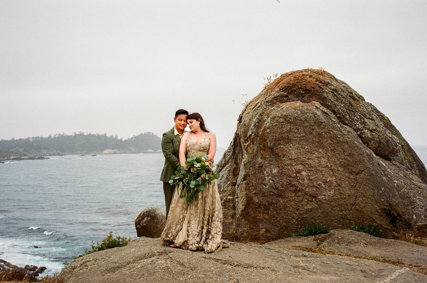 Scenic coastal wedding photos with rocky cliffs and ocean views.