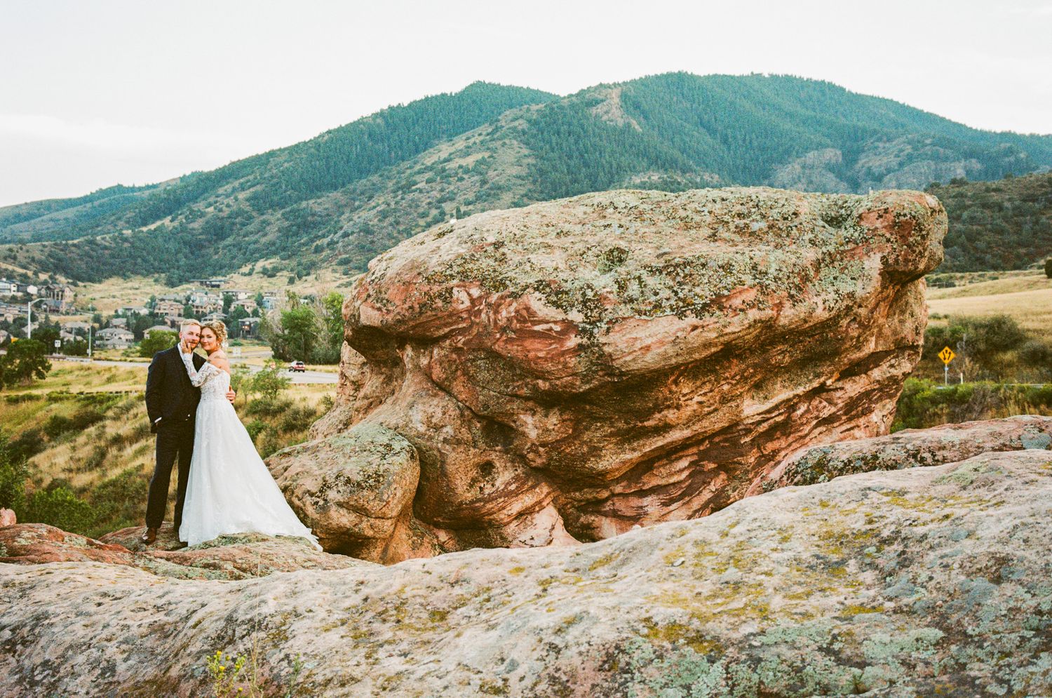 Panoramic mountain landscape with red rock formations and scenic overlooks at sunset.