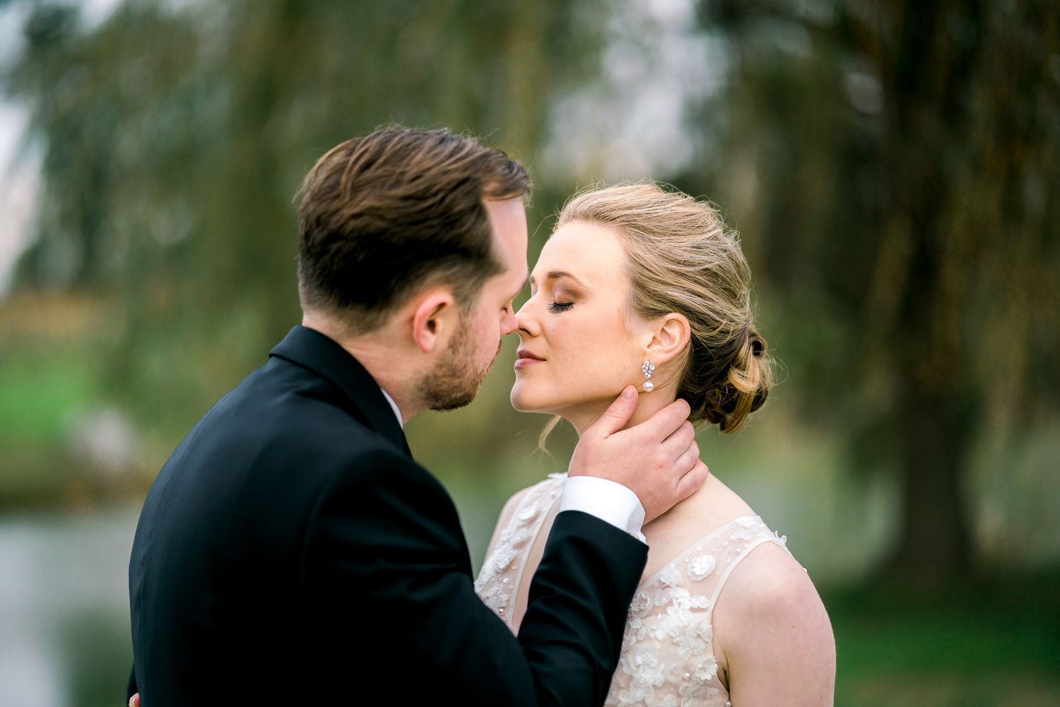 Intimate wedding moment captured in natural outdoor setting.
