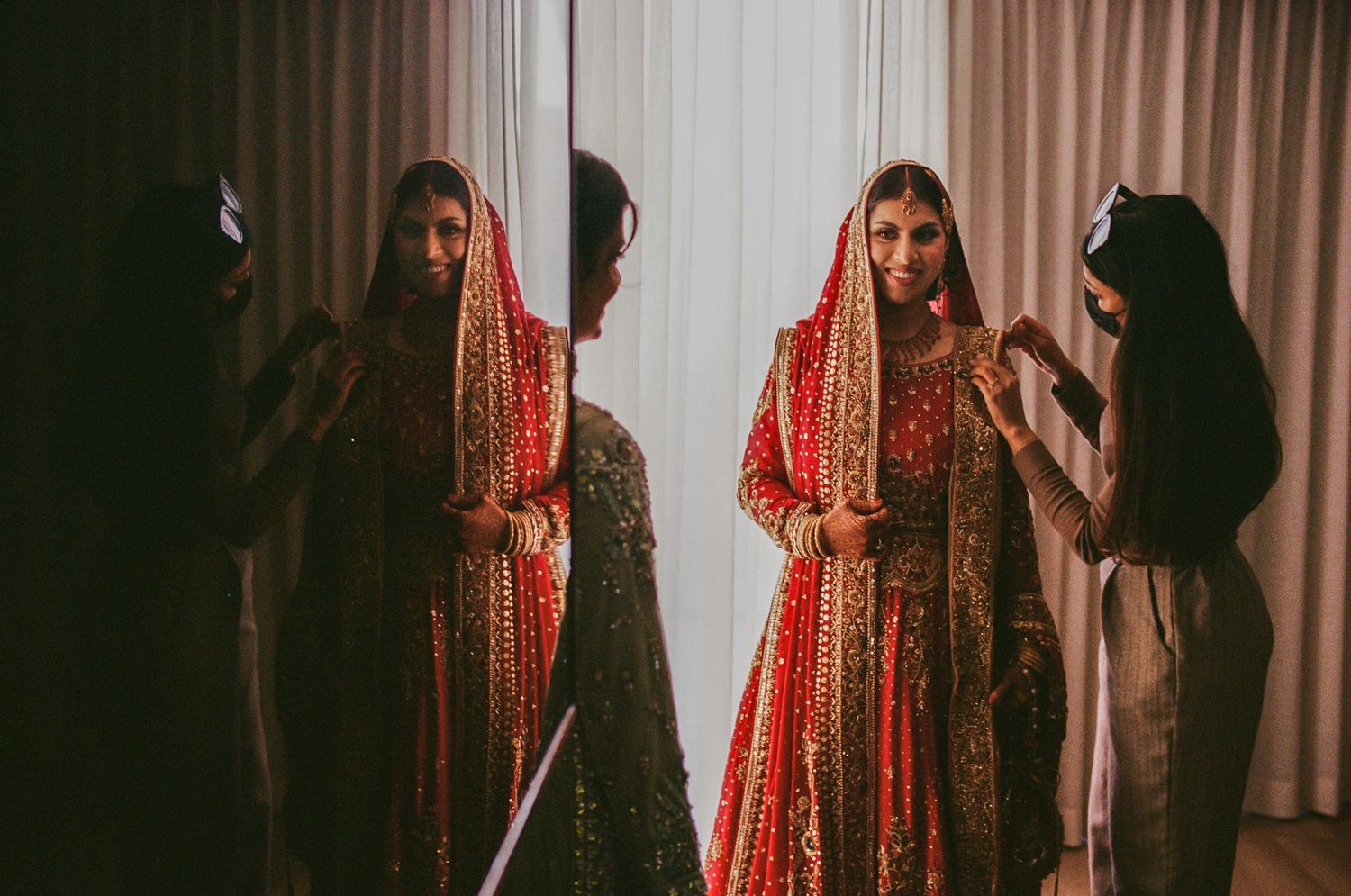 Wedding preparation scene with red dresses hanging in a dimly lit room.