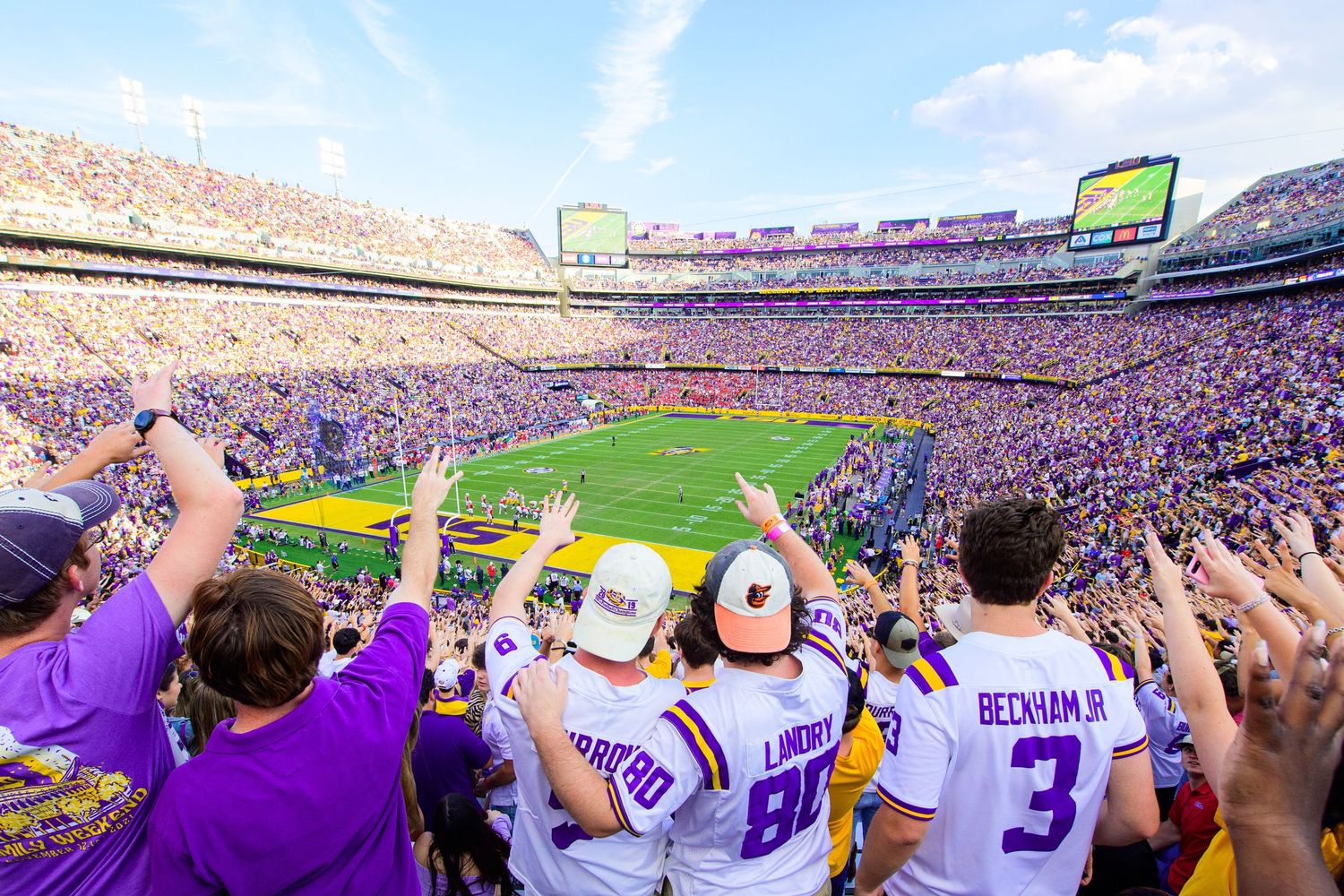LSU football fans celebrate and cheer during a packed game at Tiger Stadium in Baton Rouge, Louisiana.