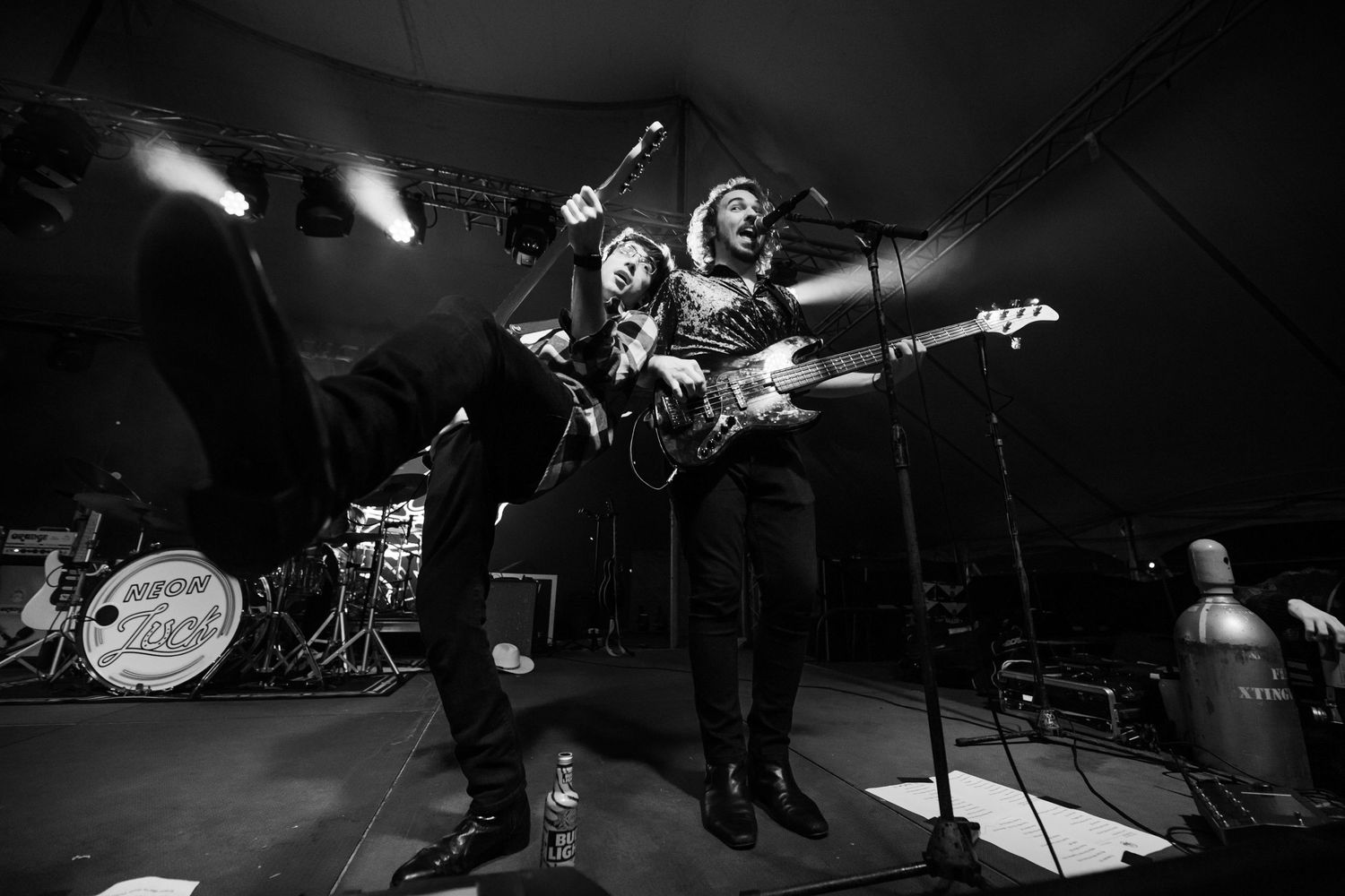 Black and white photo of musicians performing on stage with dramatic lighting.