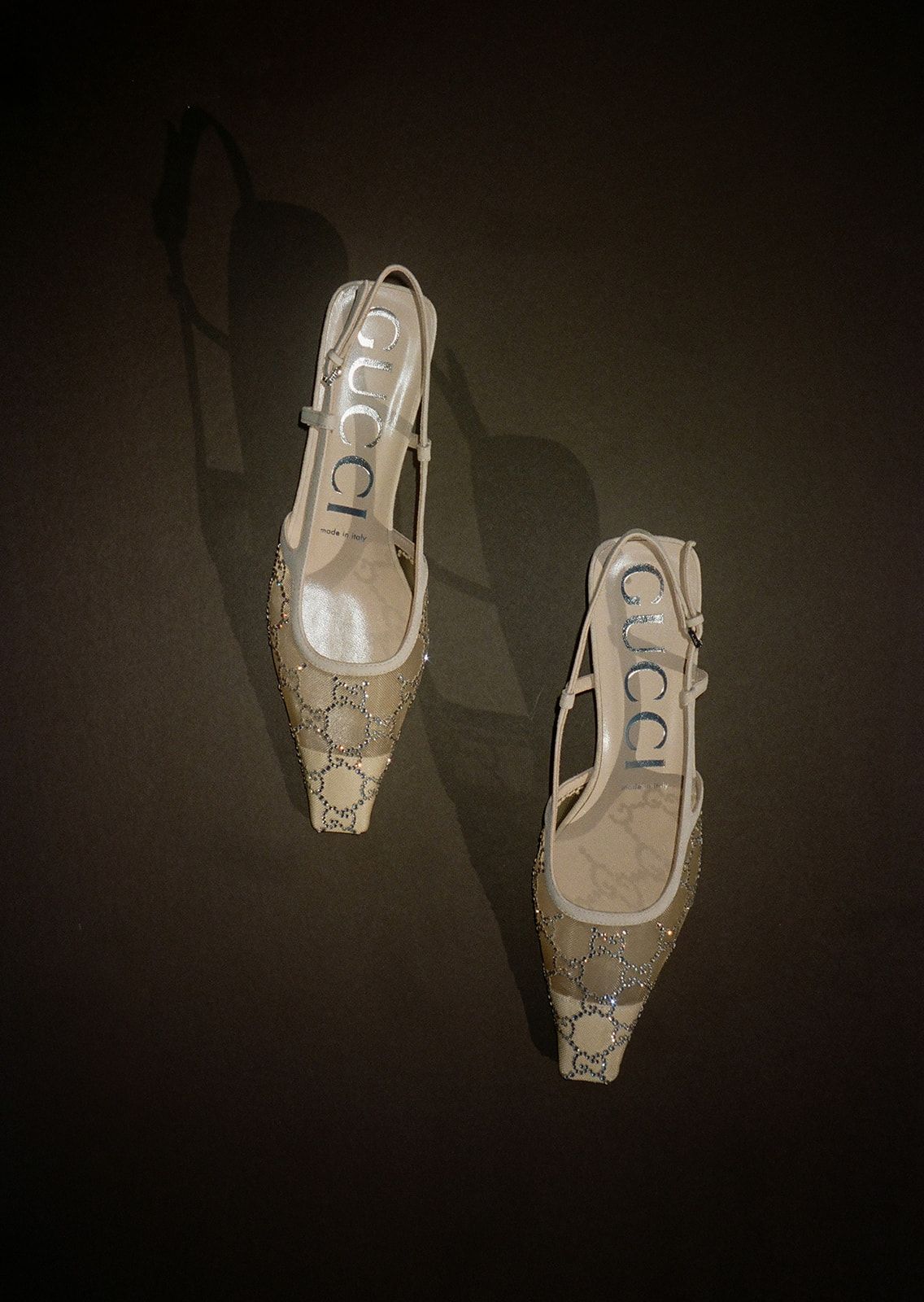 A sequence of five images showing a light-colored computer mouse casting shadows against a dark background.