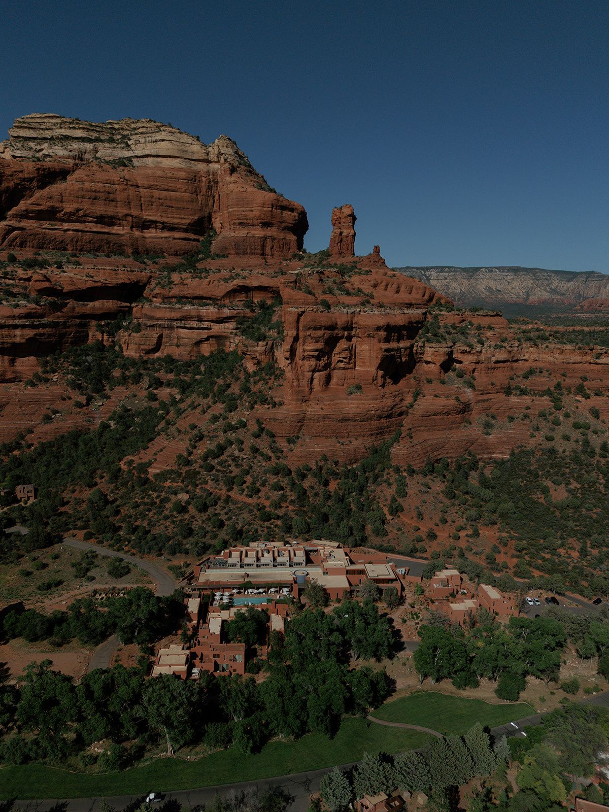 Panoramic view of majestic red rock formations at Chapel of the Holy Cross in Sedona, Arizona against blue sky.