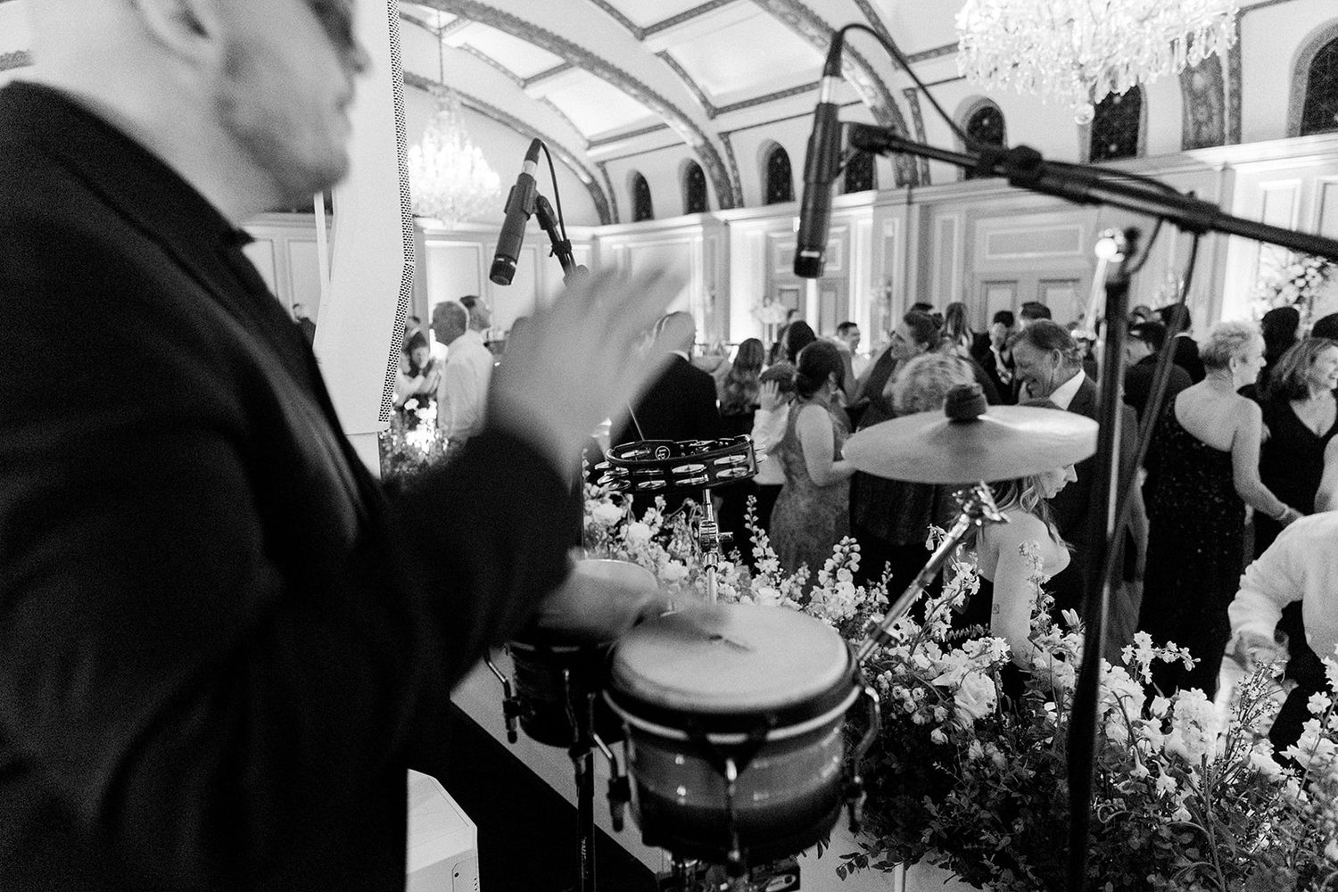 Percussionist playing at an elegant indoor wedding reception with decorative lighting.