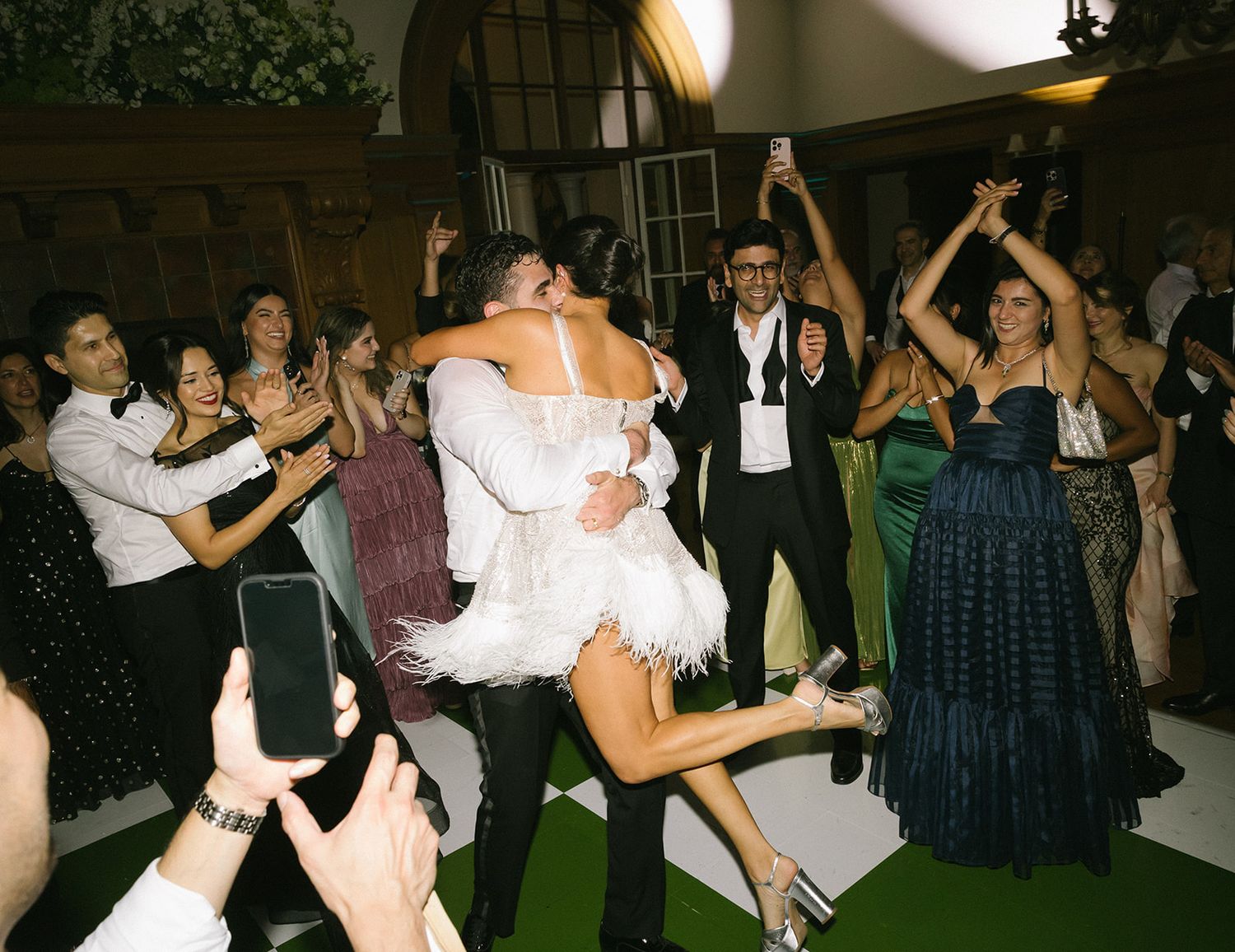 A group of people dancing together at a lively nighttime party or celebration event.