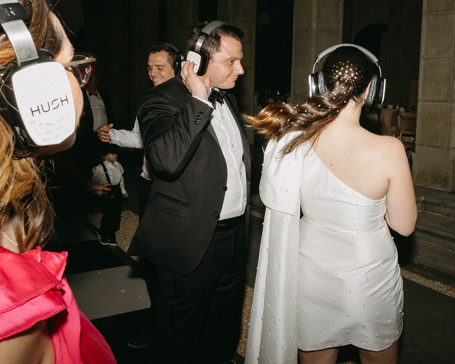 Wedding reception dance party with guests celebrating on the dance floor in formal attire.