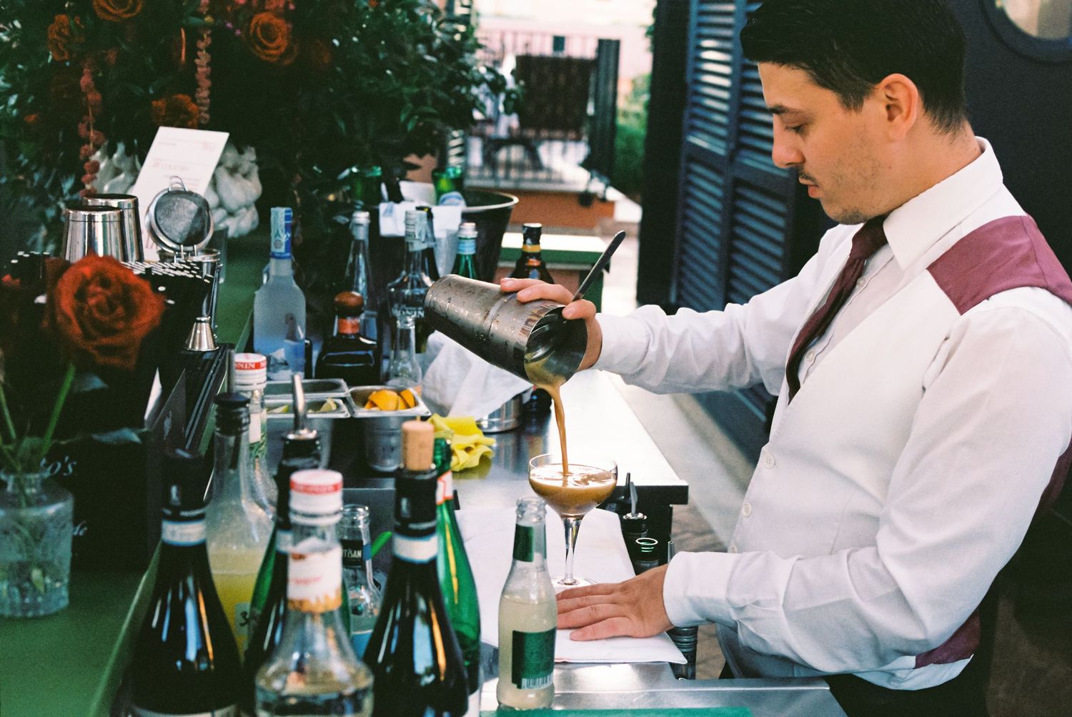 Wedding photography on film in Italy Rome. Bartender making espresso martini