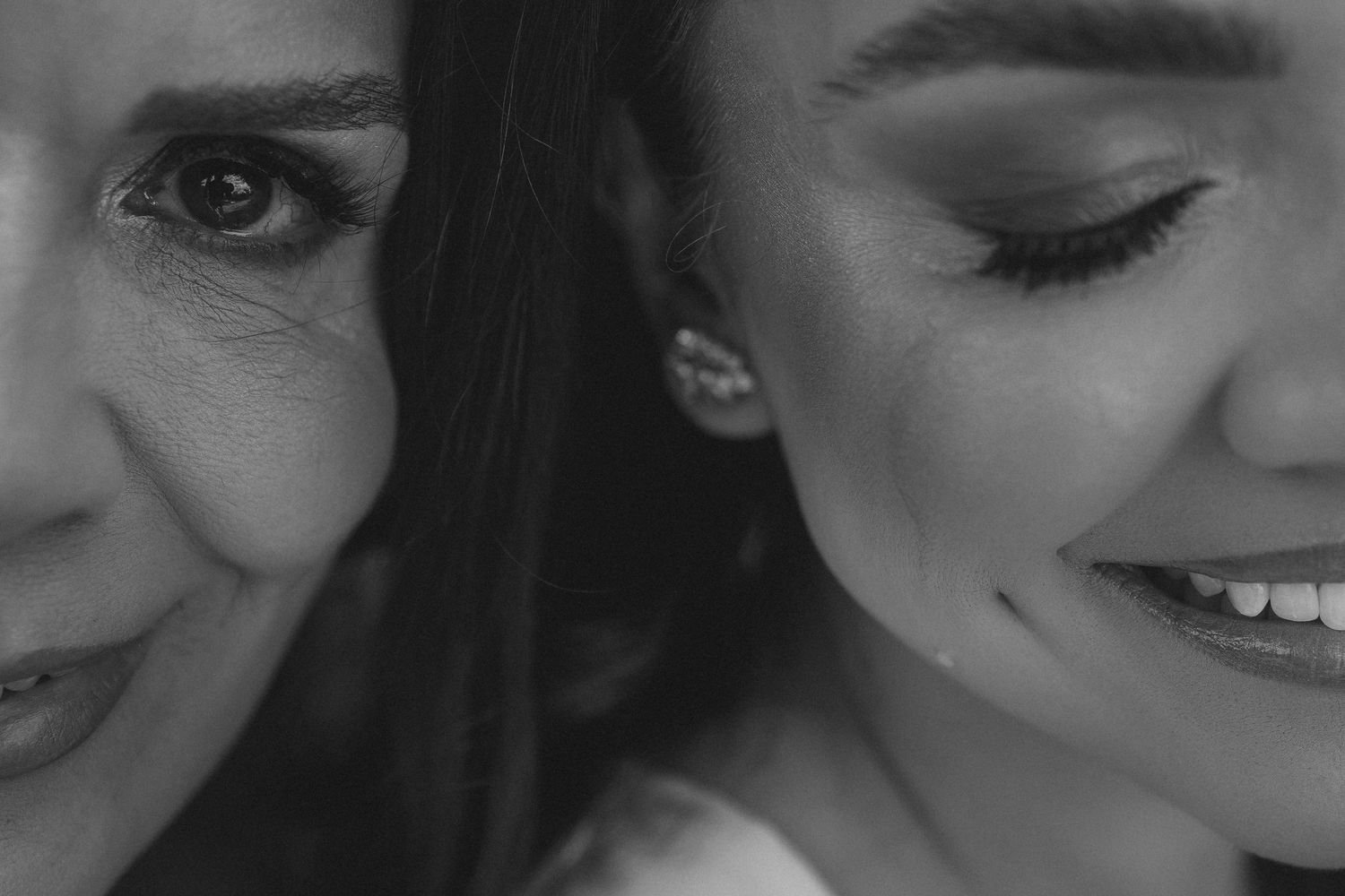 Black and white close-up portrait showing contrasting expressions of smiling and contemplation.