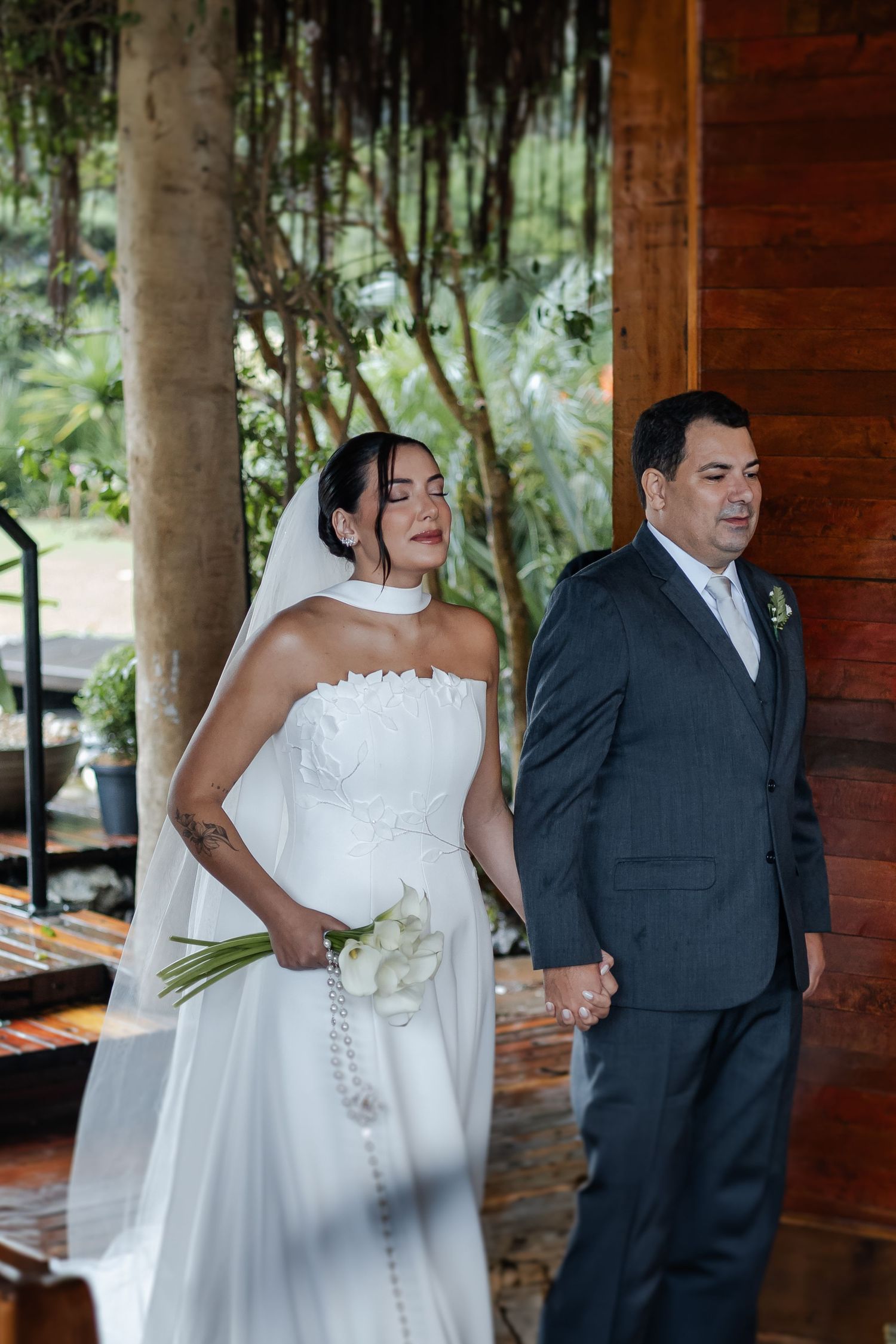 Four sequential wedding photos show a couple sharing joyful moments together in a rustic wooden pavilion setting.