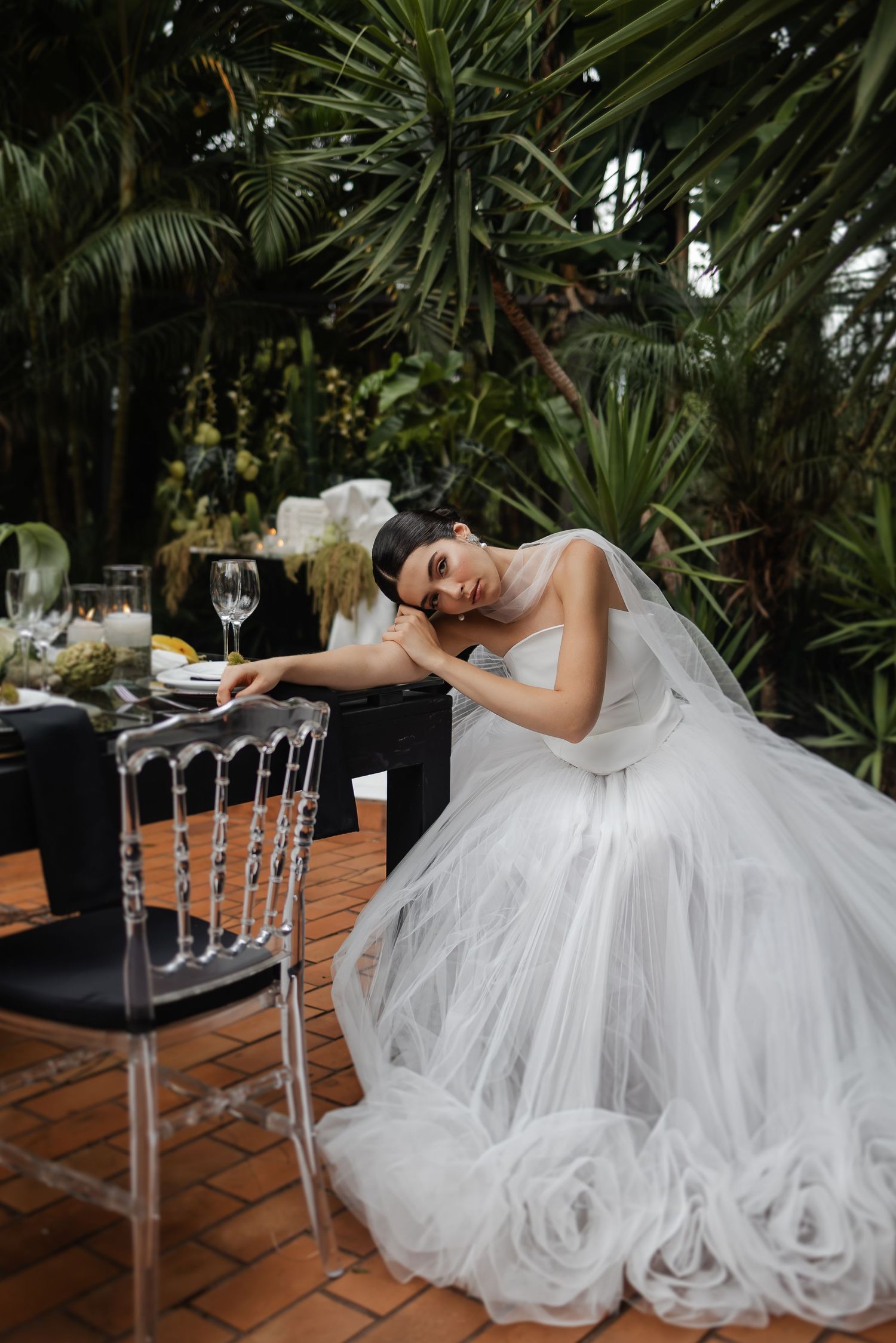 A series of artistic bridal photos showing a flowing white wedding dress draped elegantly across chairs in a tropical setting.