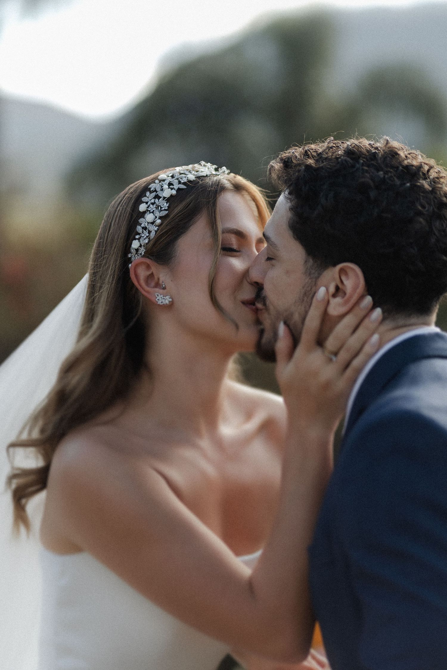 A romantic close-up sequence shows a newlywed couple sharing a tender kiss during their wedding celebration.