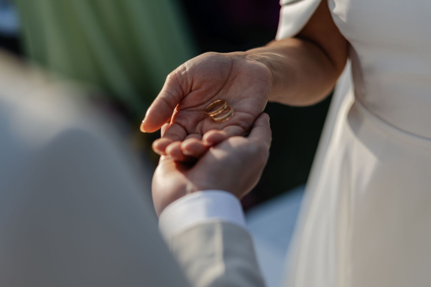 Closeup of two hands reaching out to hold each other during an emotional moment.