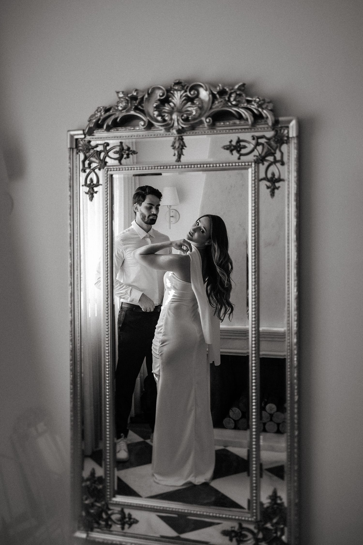 A series of black and white mirror reflections showing a couple posing in elegant wedding attire.